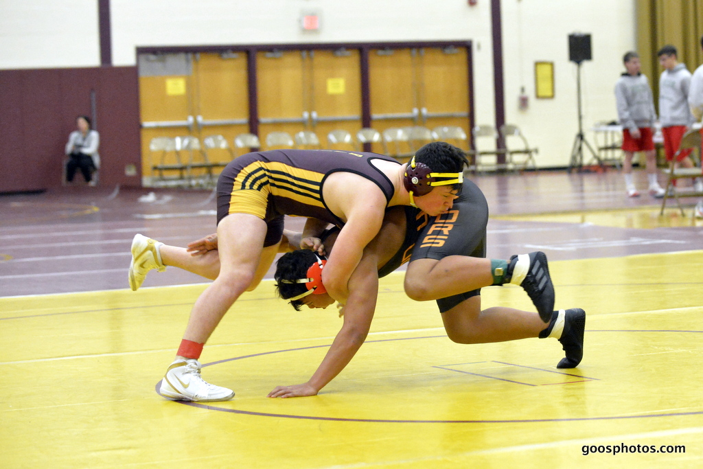 wrestlers engage in a match