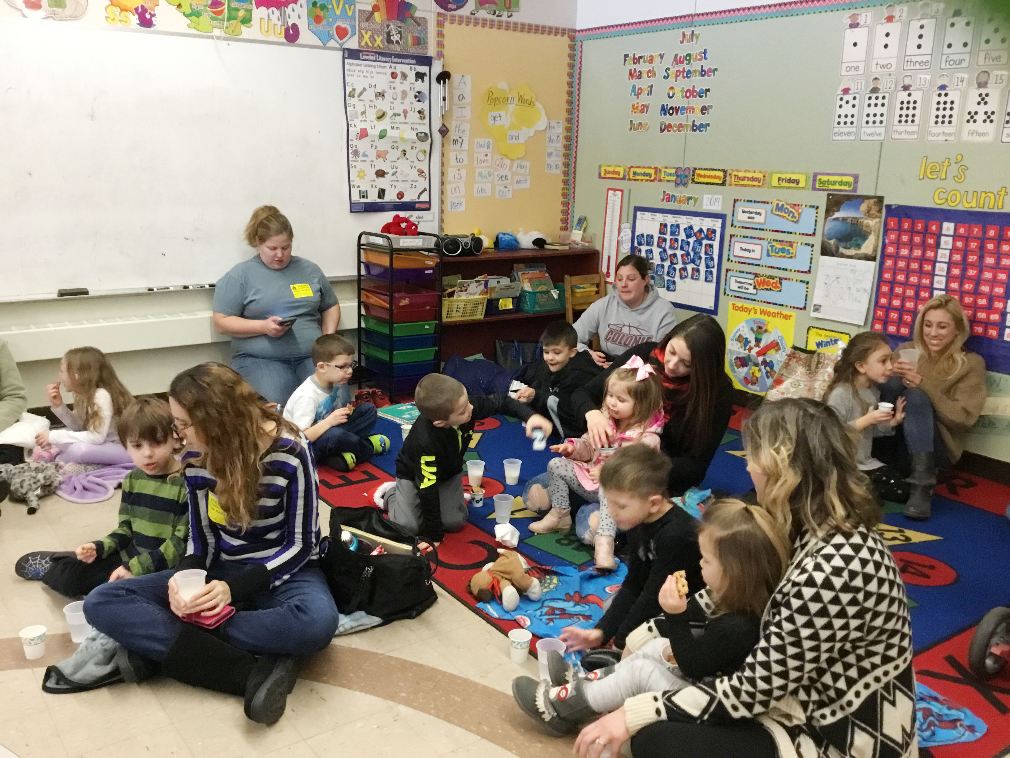 students sprawl on floor to read with their parents