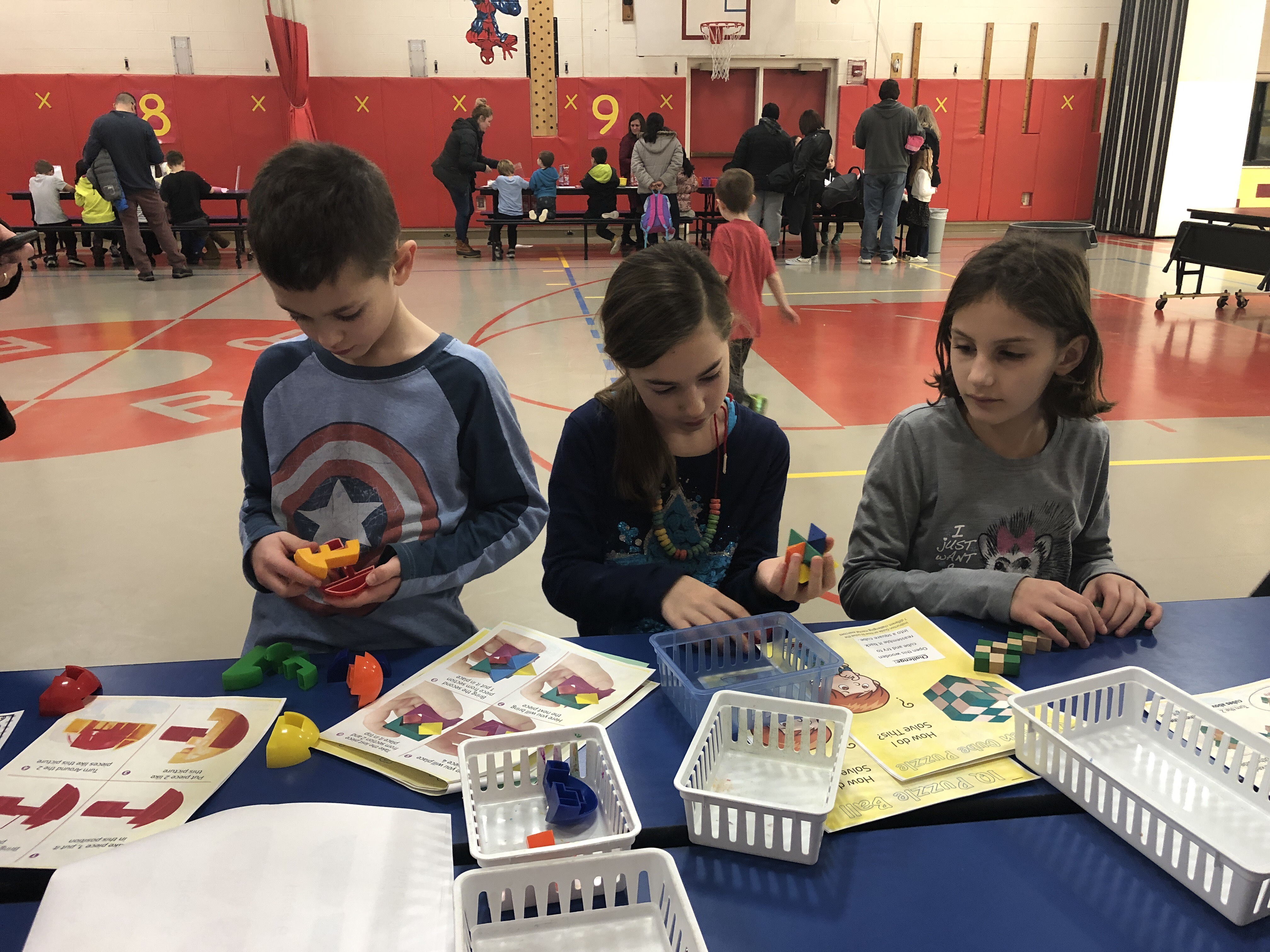 three children work on math problems together