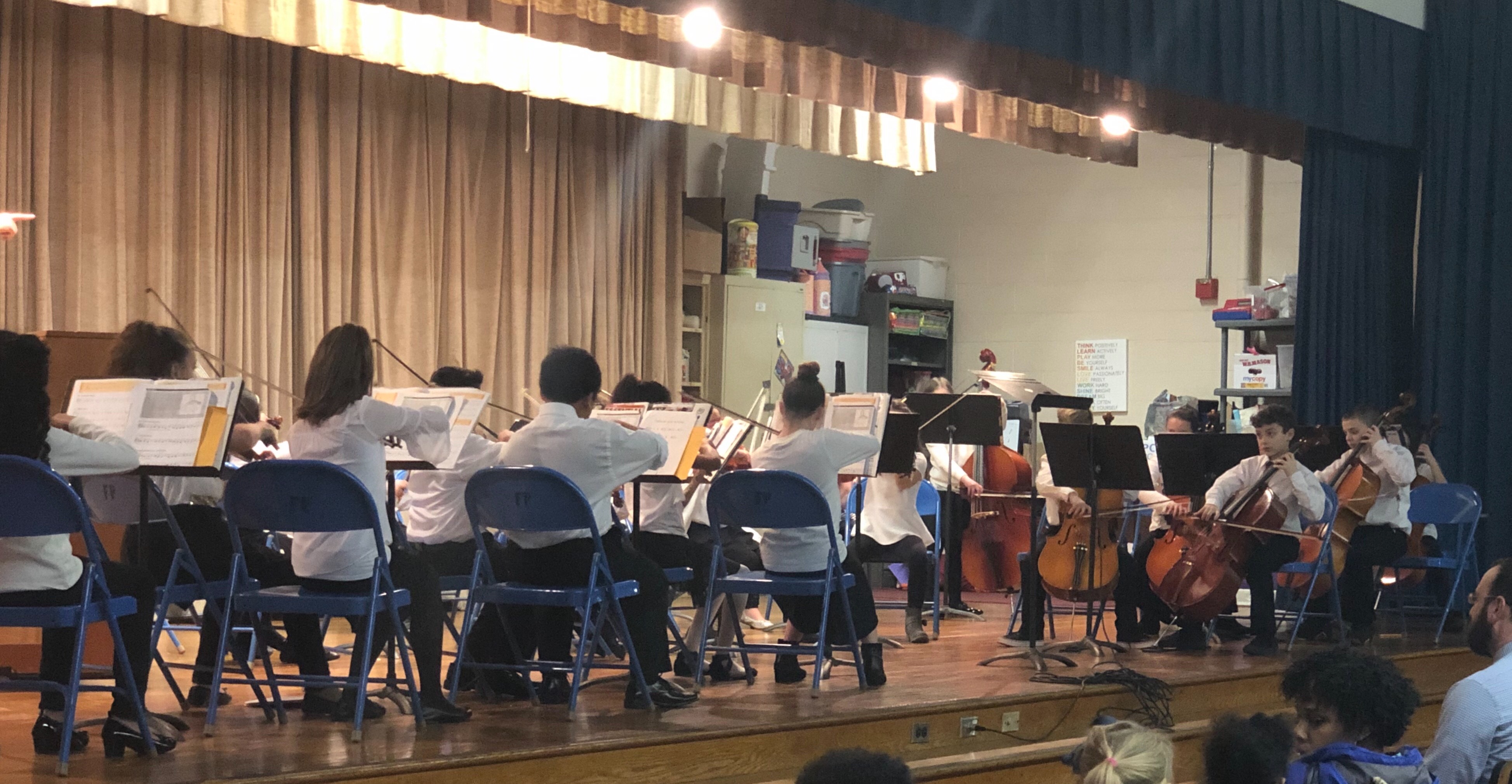 student orchestra performs on stage