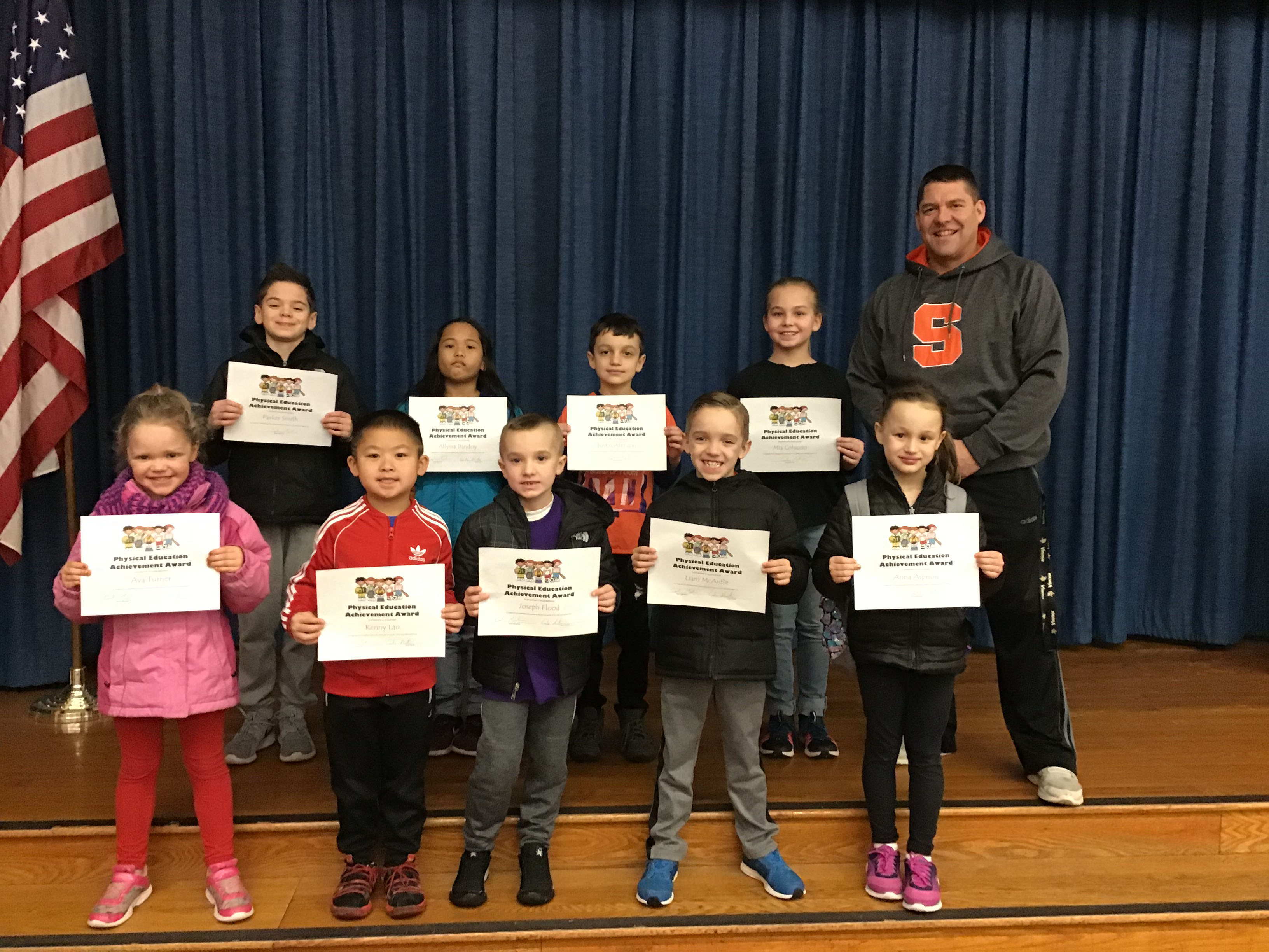 group of student stand with their award certificates