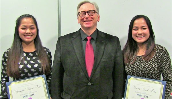 two asian student with their award certificates