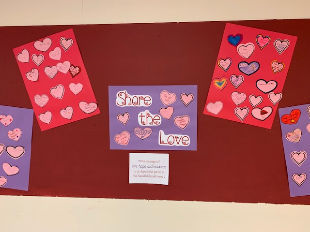 bulletin board covered with paper hearts and message of hope