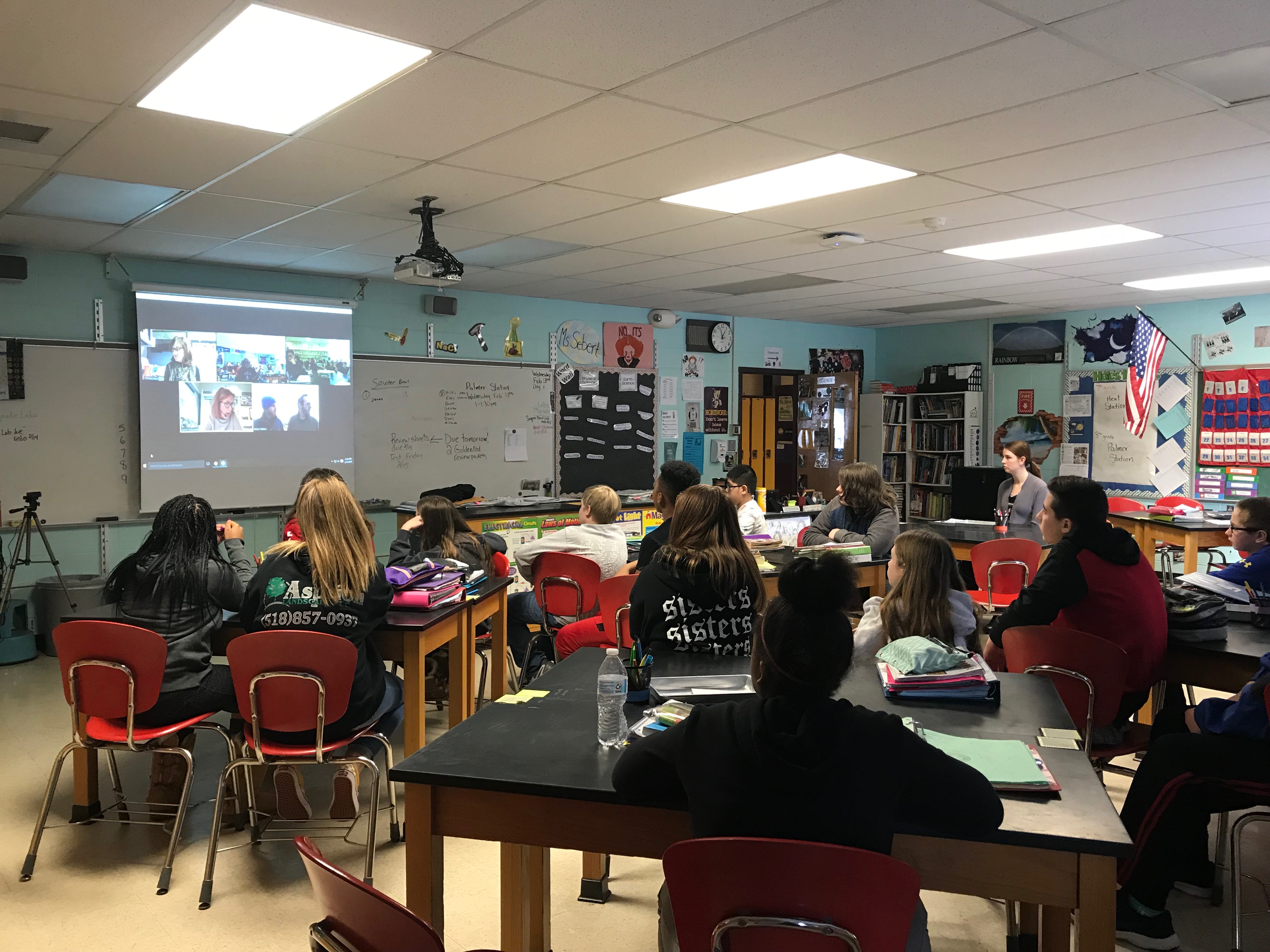 class full of students participate in a video conference