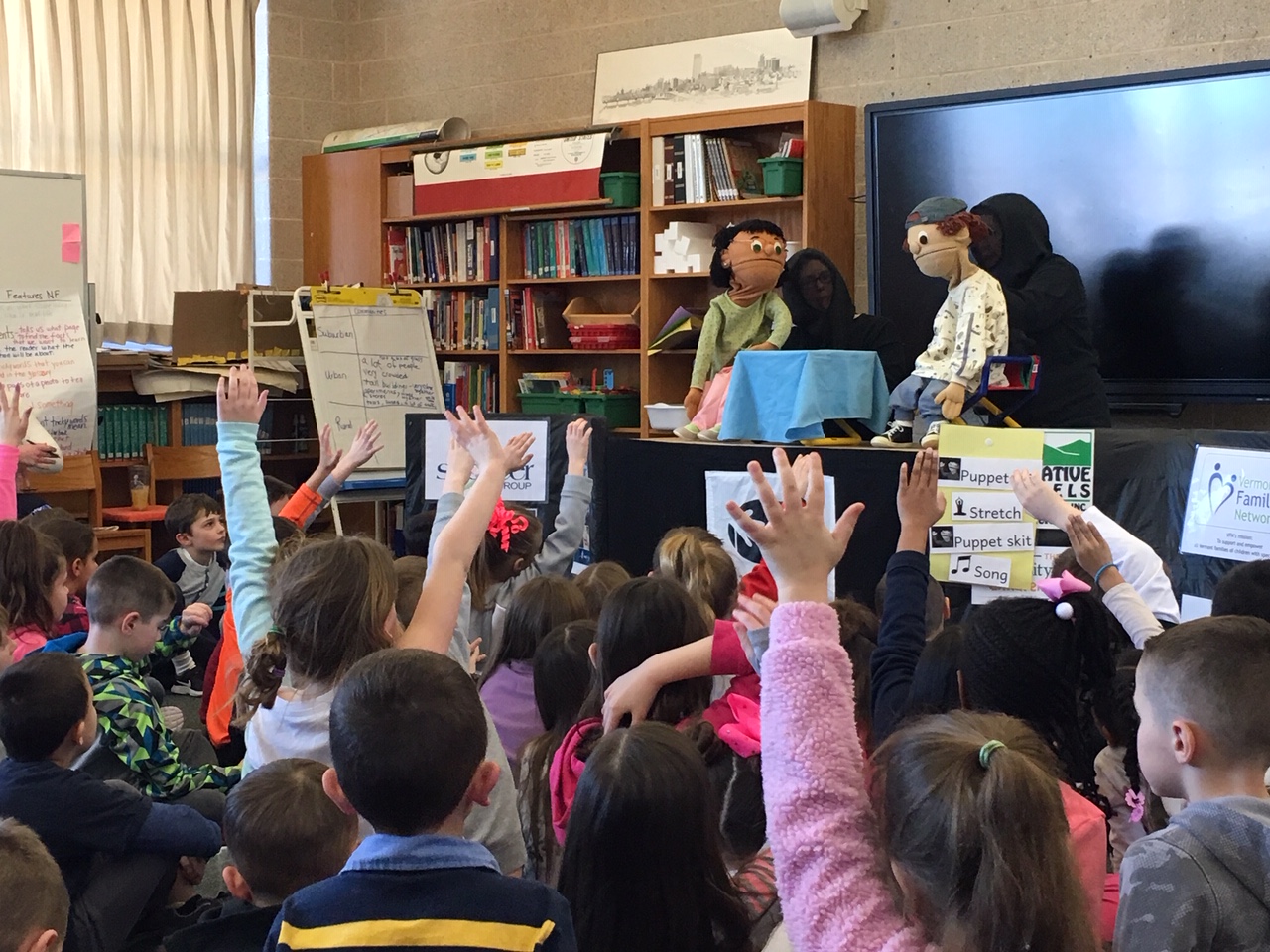 group of children enjoy a puppet show