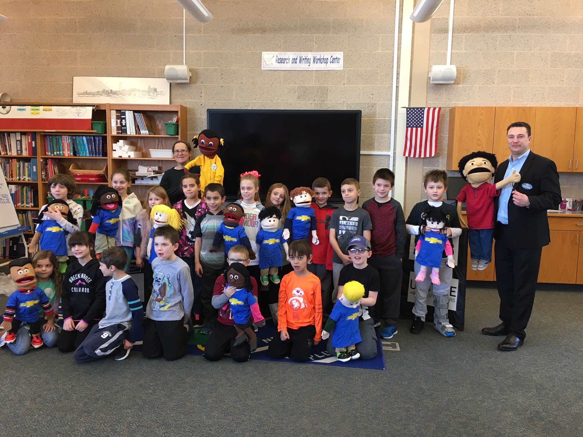 group of student pose with puppeteers