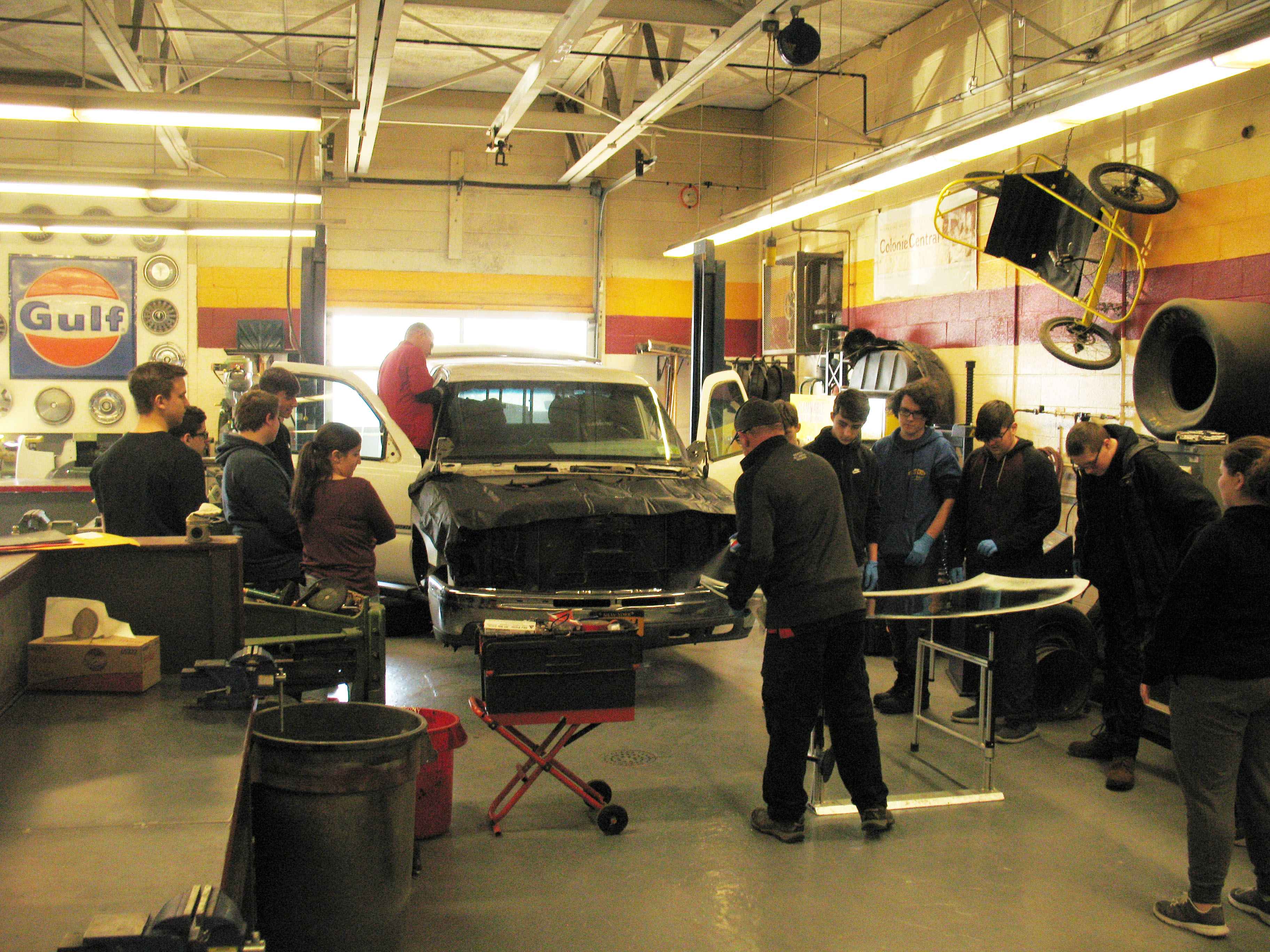 students in auto shop witness a car windshield replacement