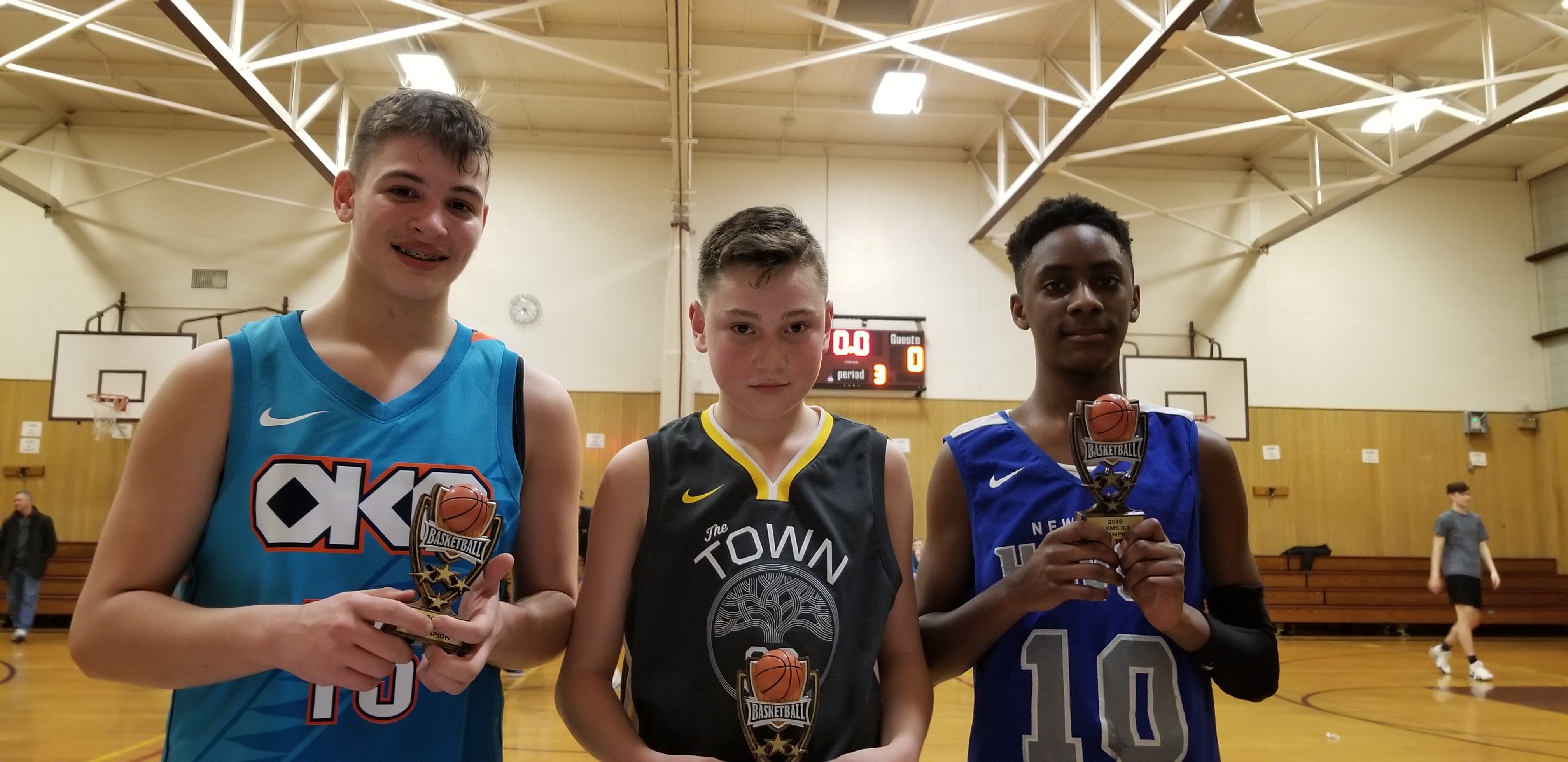 3 boys in their basketball uniforms