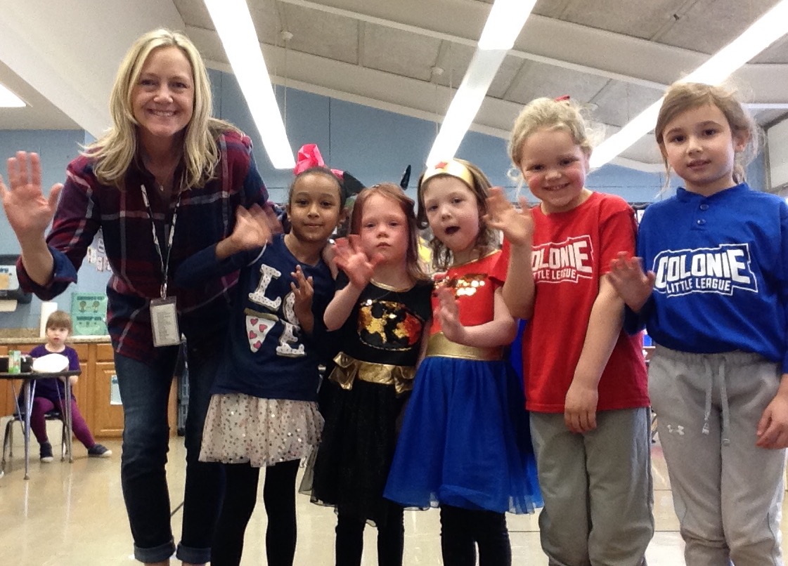 five students dressed in costume with their teacher