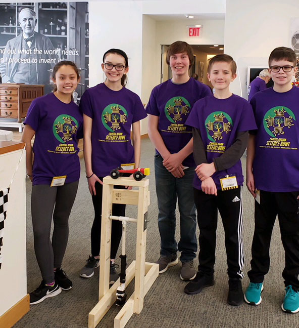 middle school student group with their wooden invention