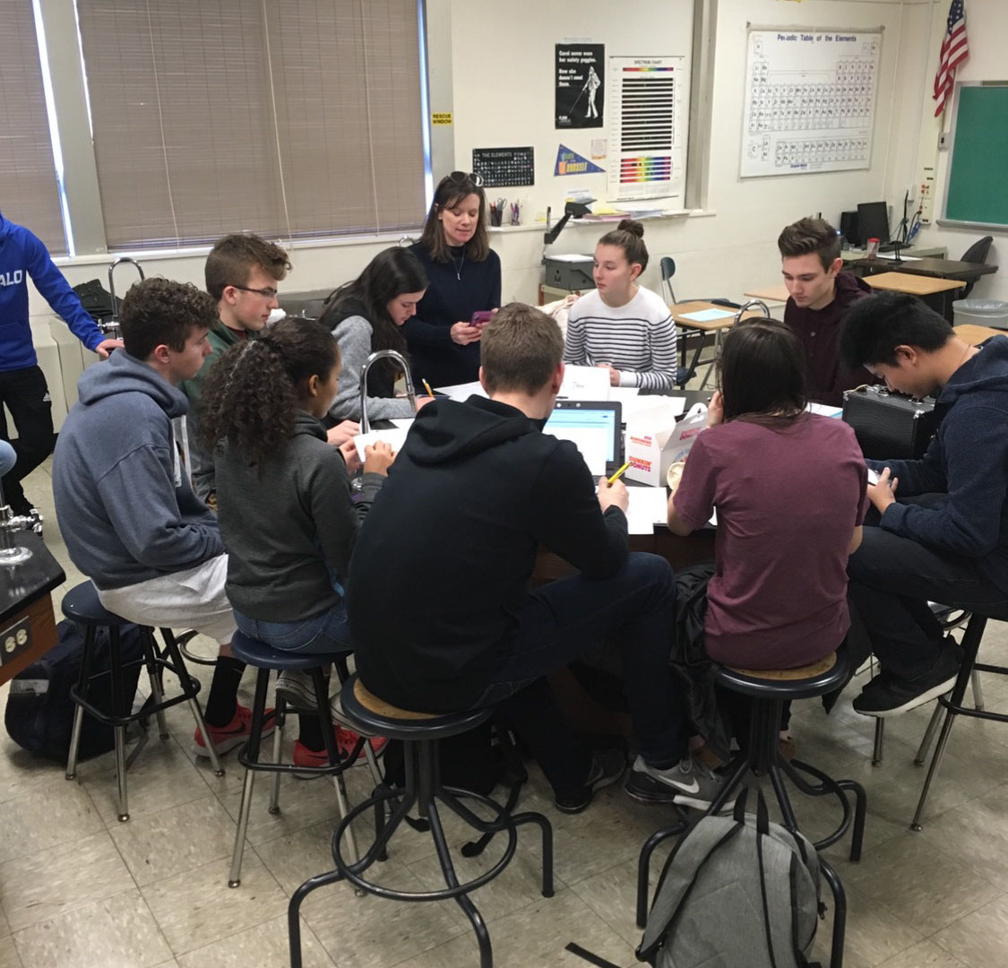 high school students work on a project in a group