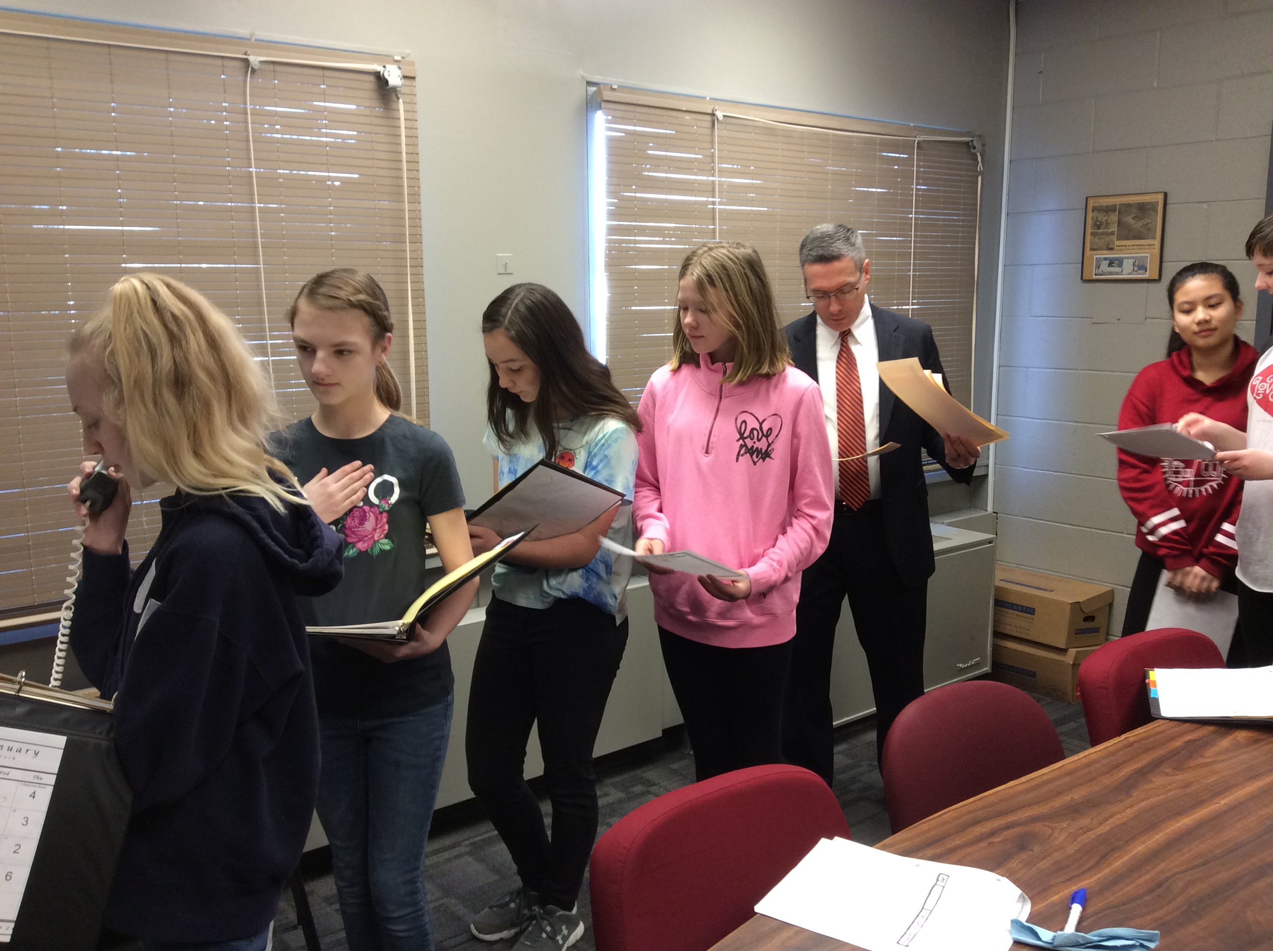 students line up to read at the microphone