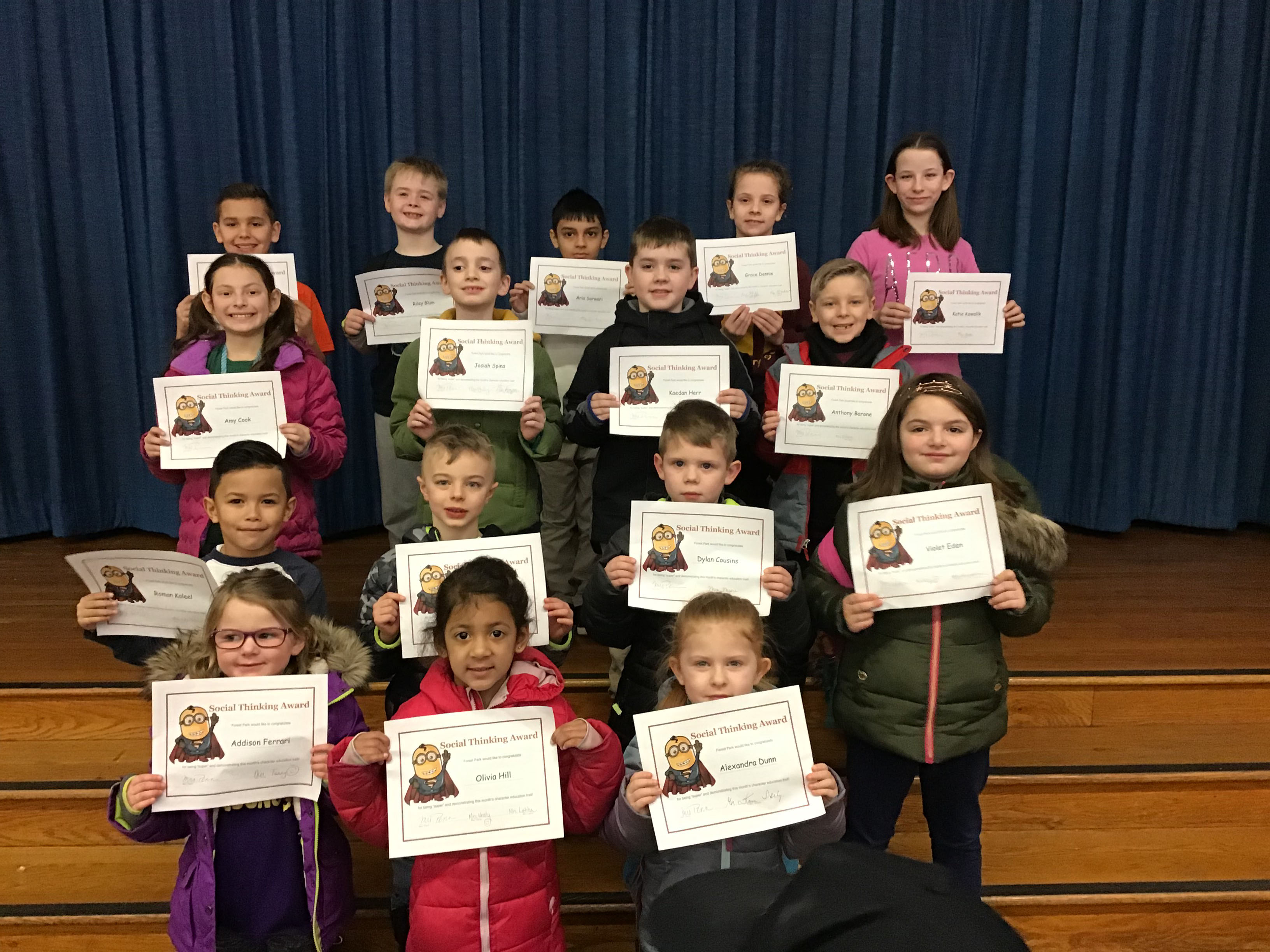 students display their award certificates