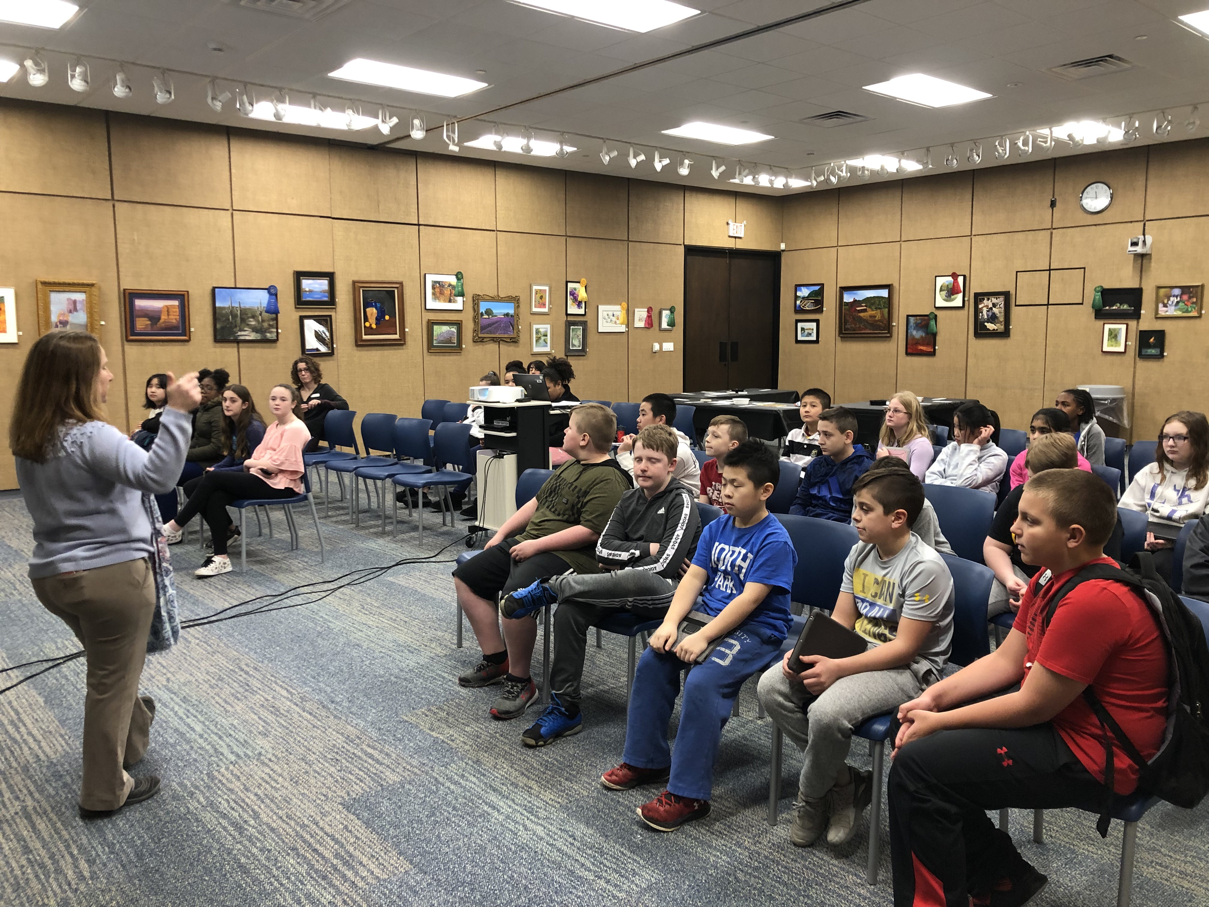 group of students are instructed by a librarian