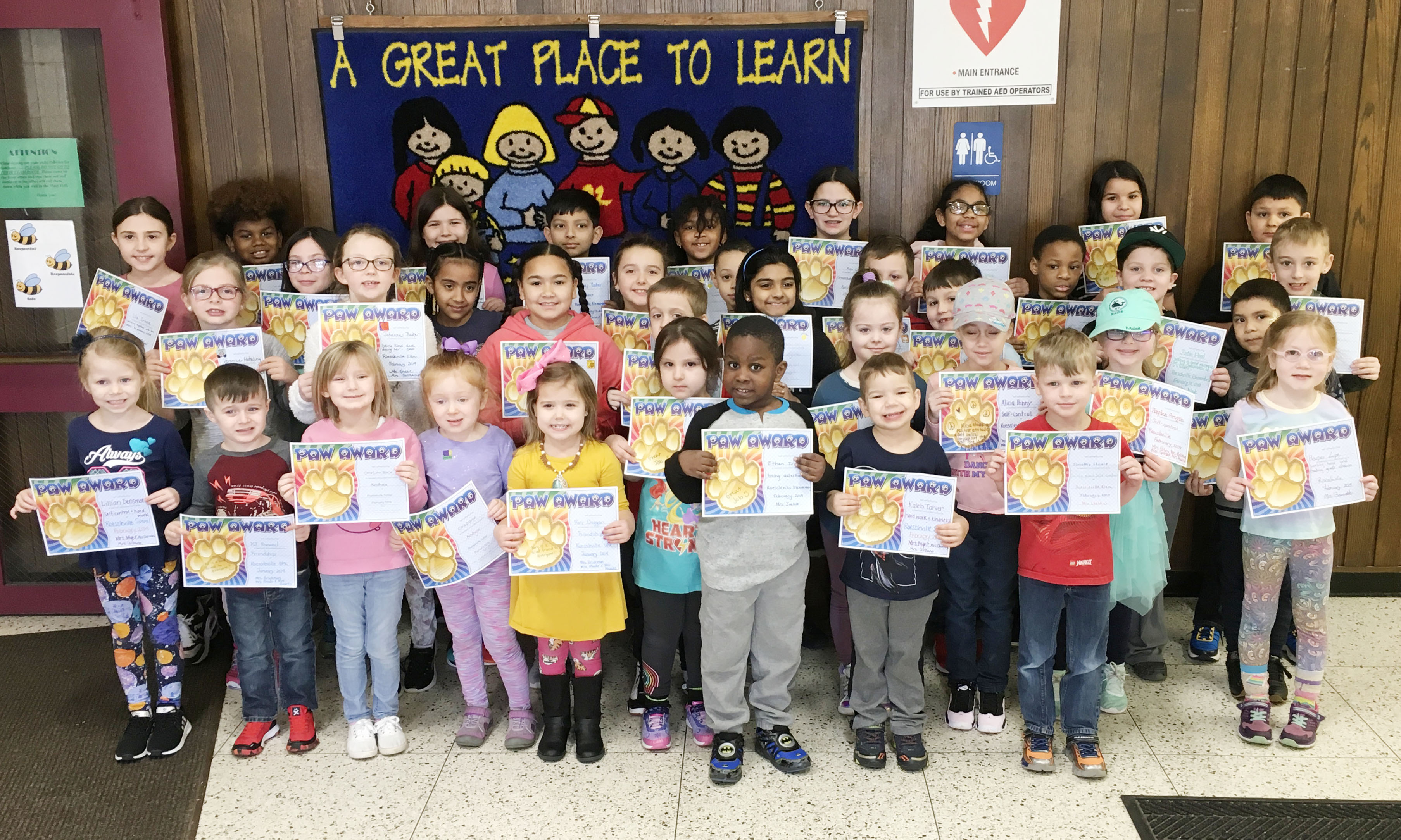 group of students hold their award certificates