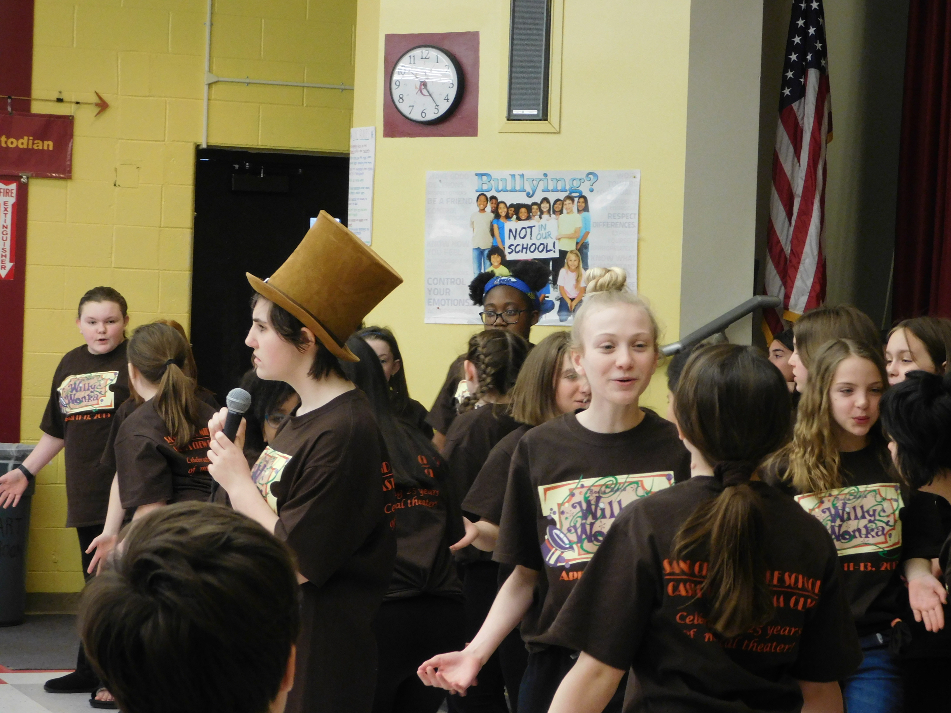 boy in Willy Wonka hat performs with others