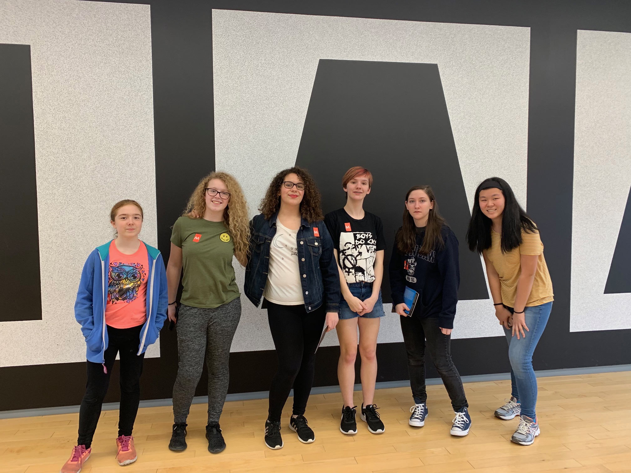 group of student pose at art museum