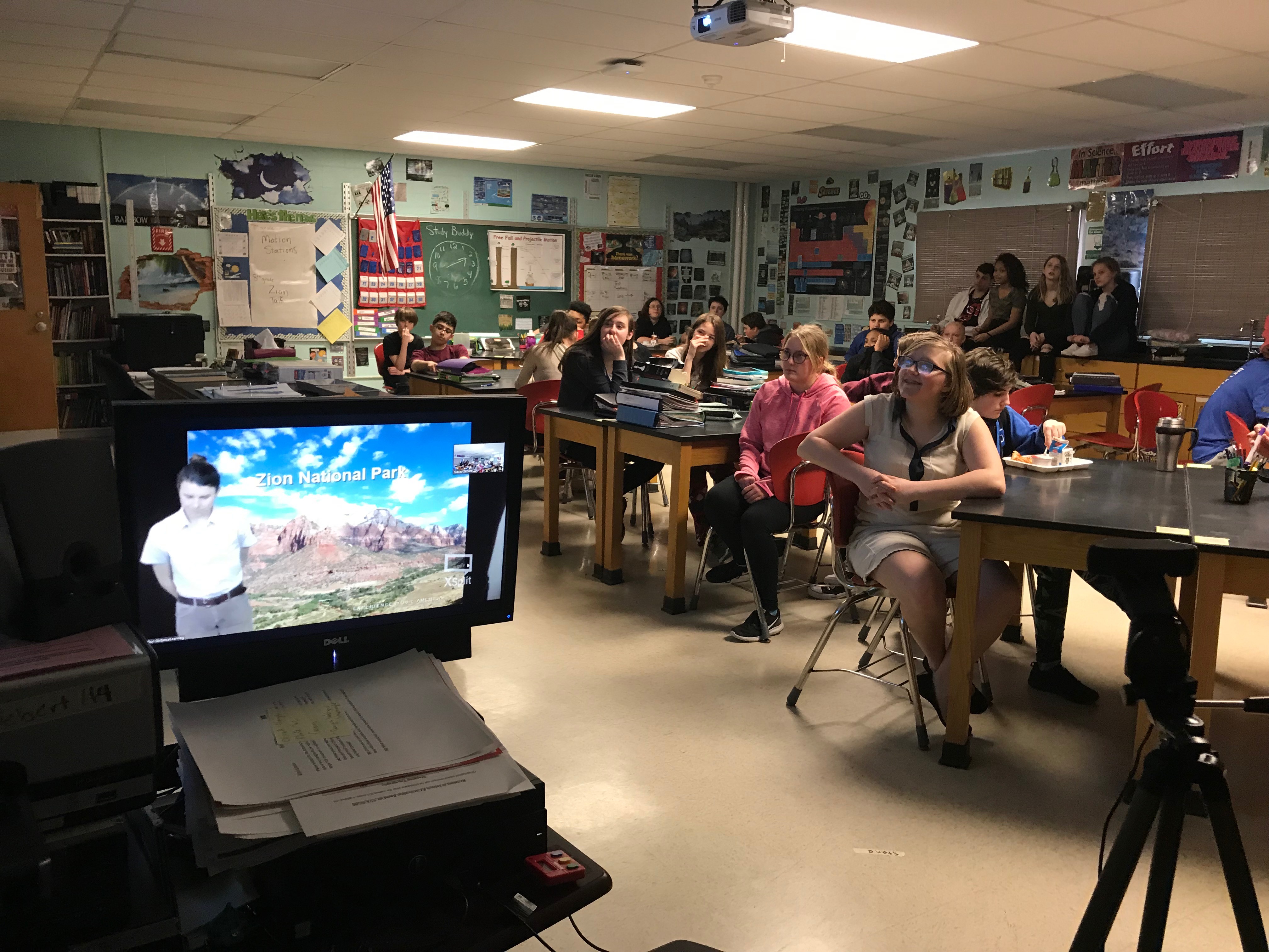 students participate in video conference in a classroom