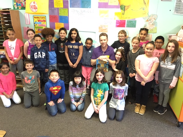 book reader poses with third grade class