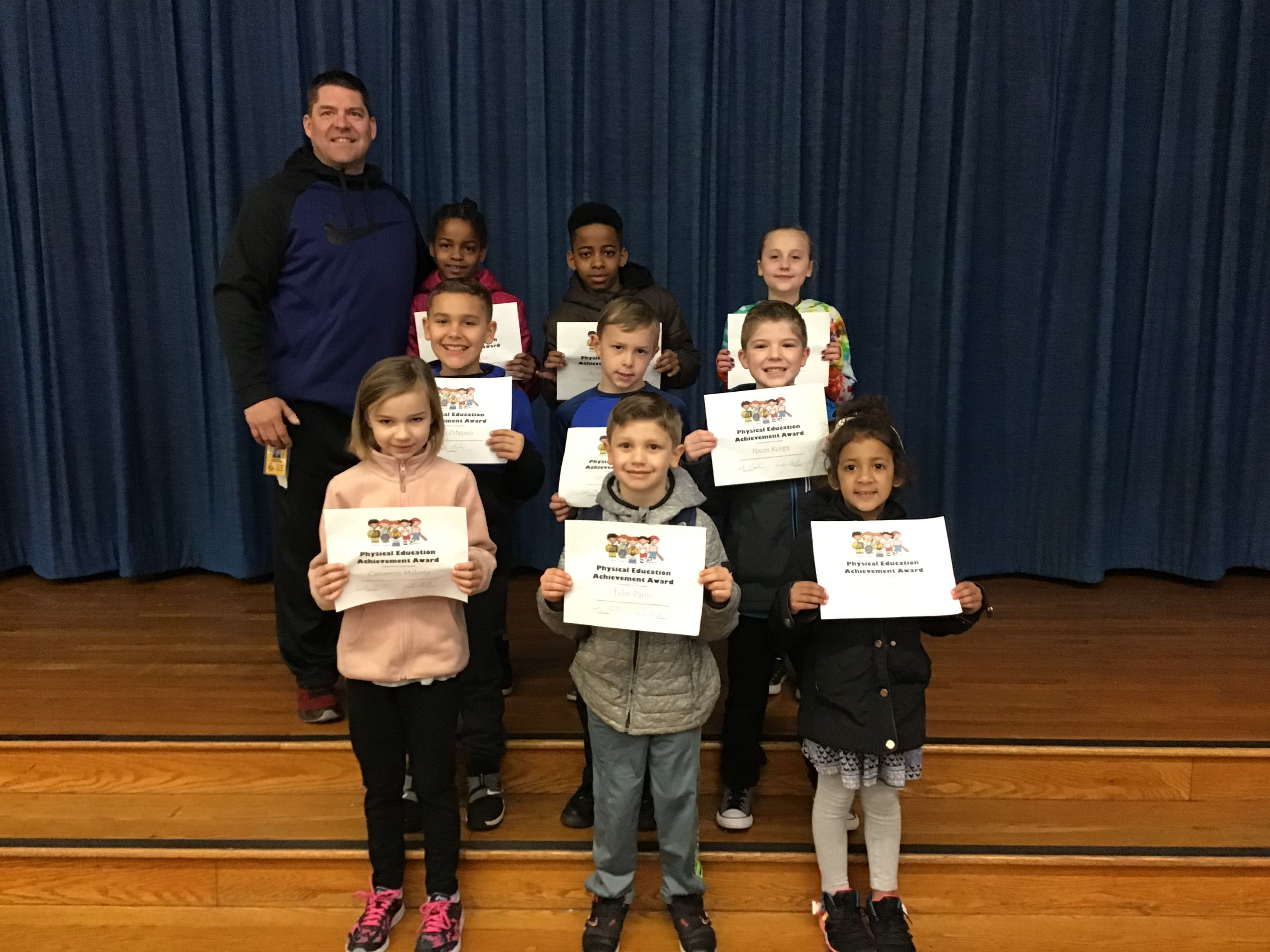 group of students hold their award certificates