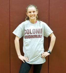 girl stands in her Colonie T shirt