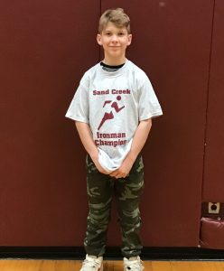 boy stands in his gym shirt