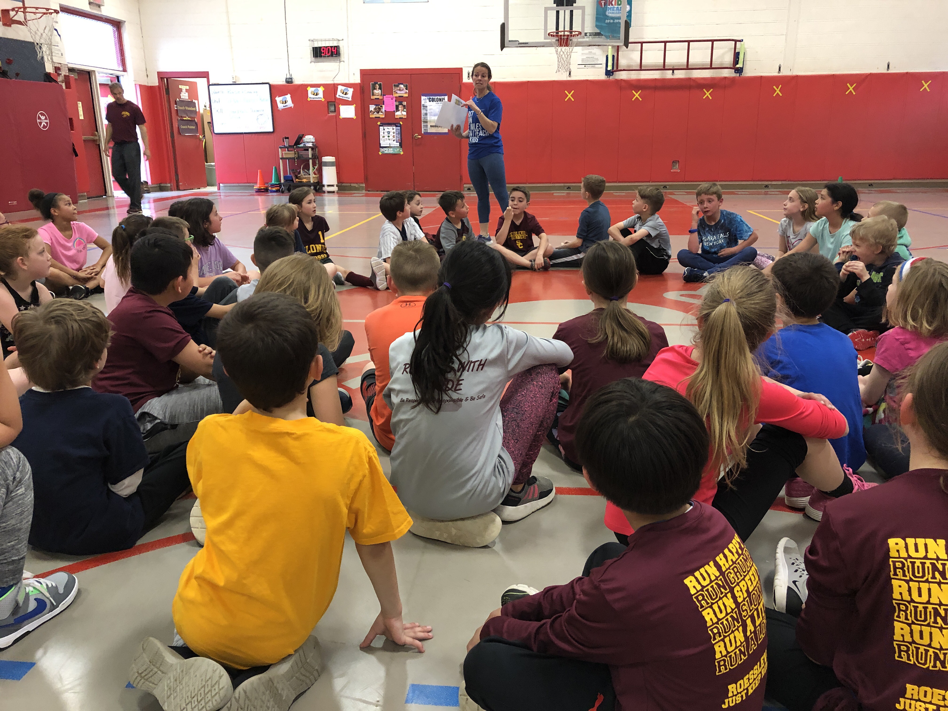 group of runners gather on gym floor