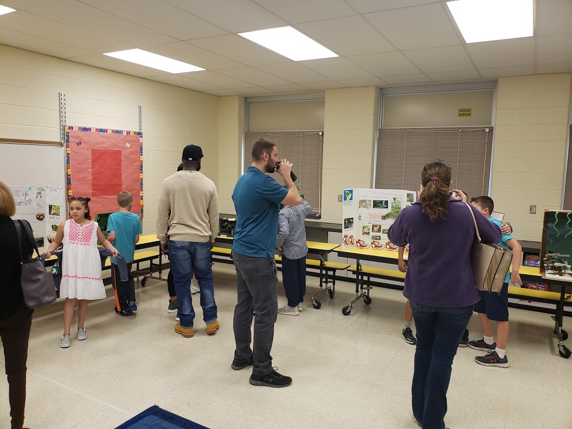 family look over student projects