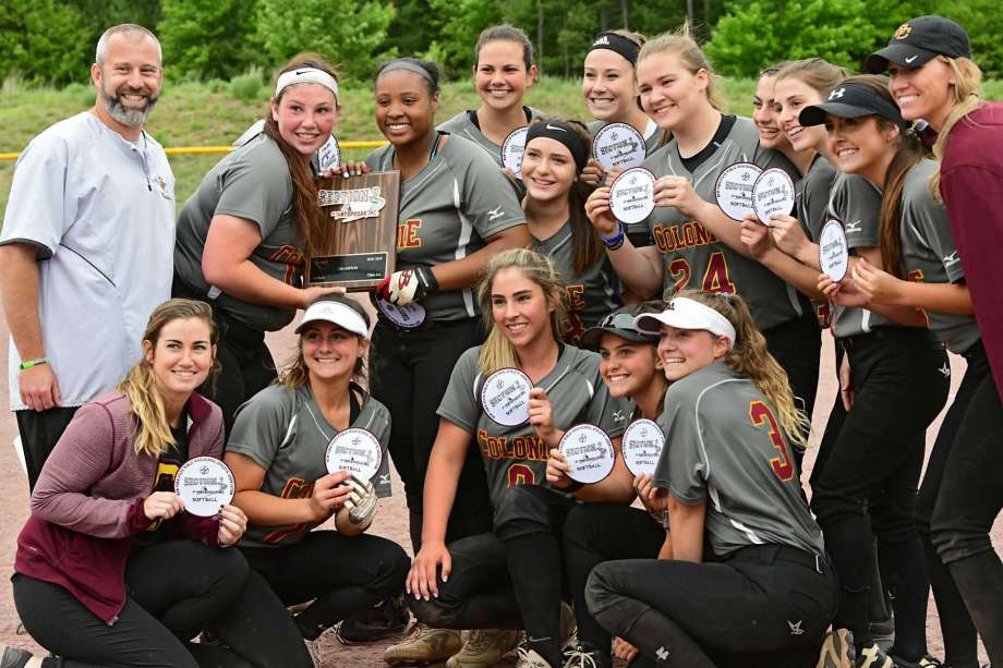 group of softball players with their trophy