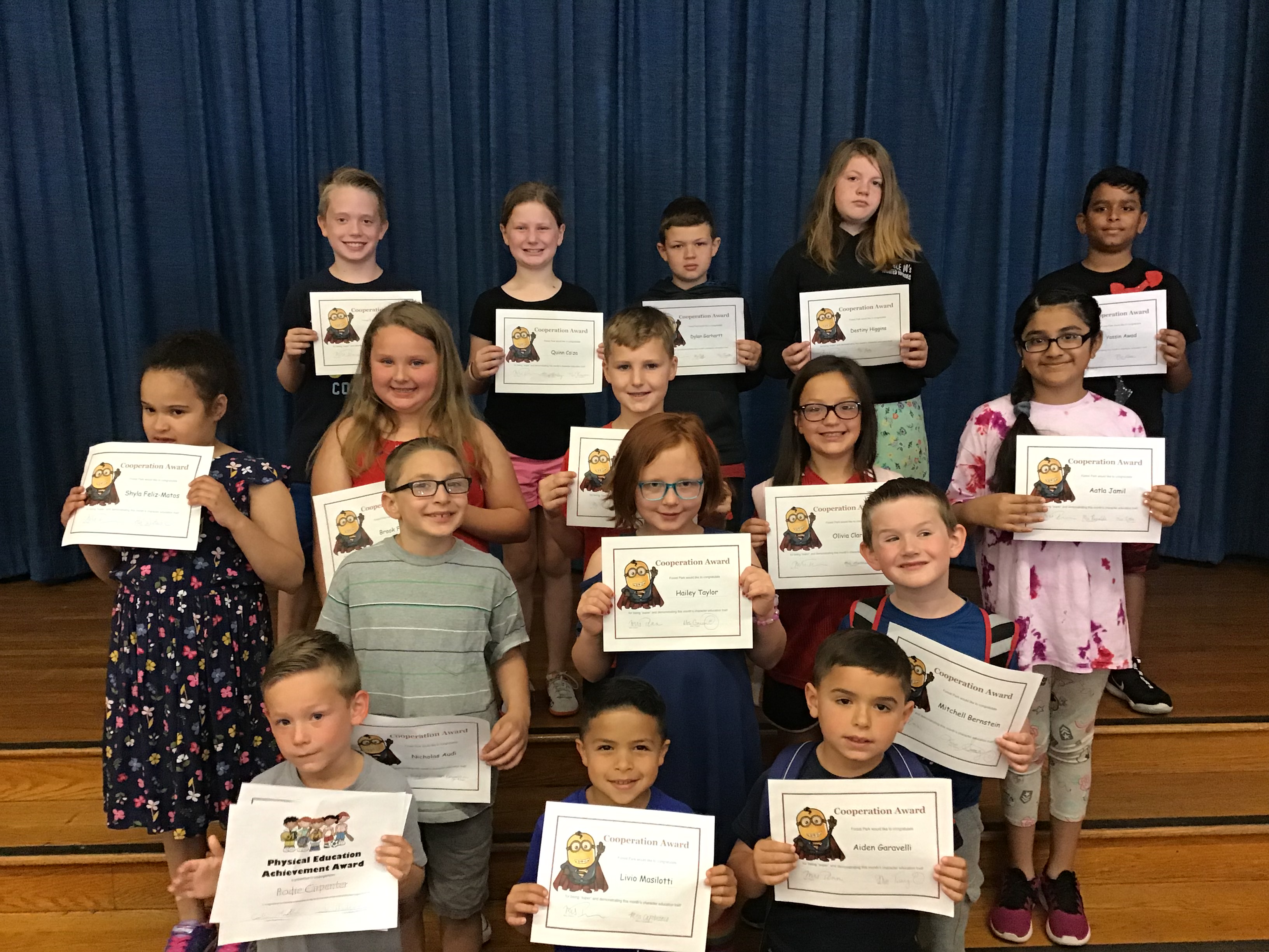 group of student show off their award certificates