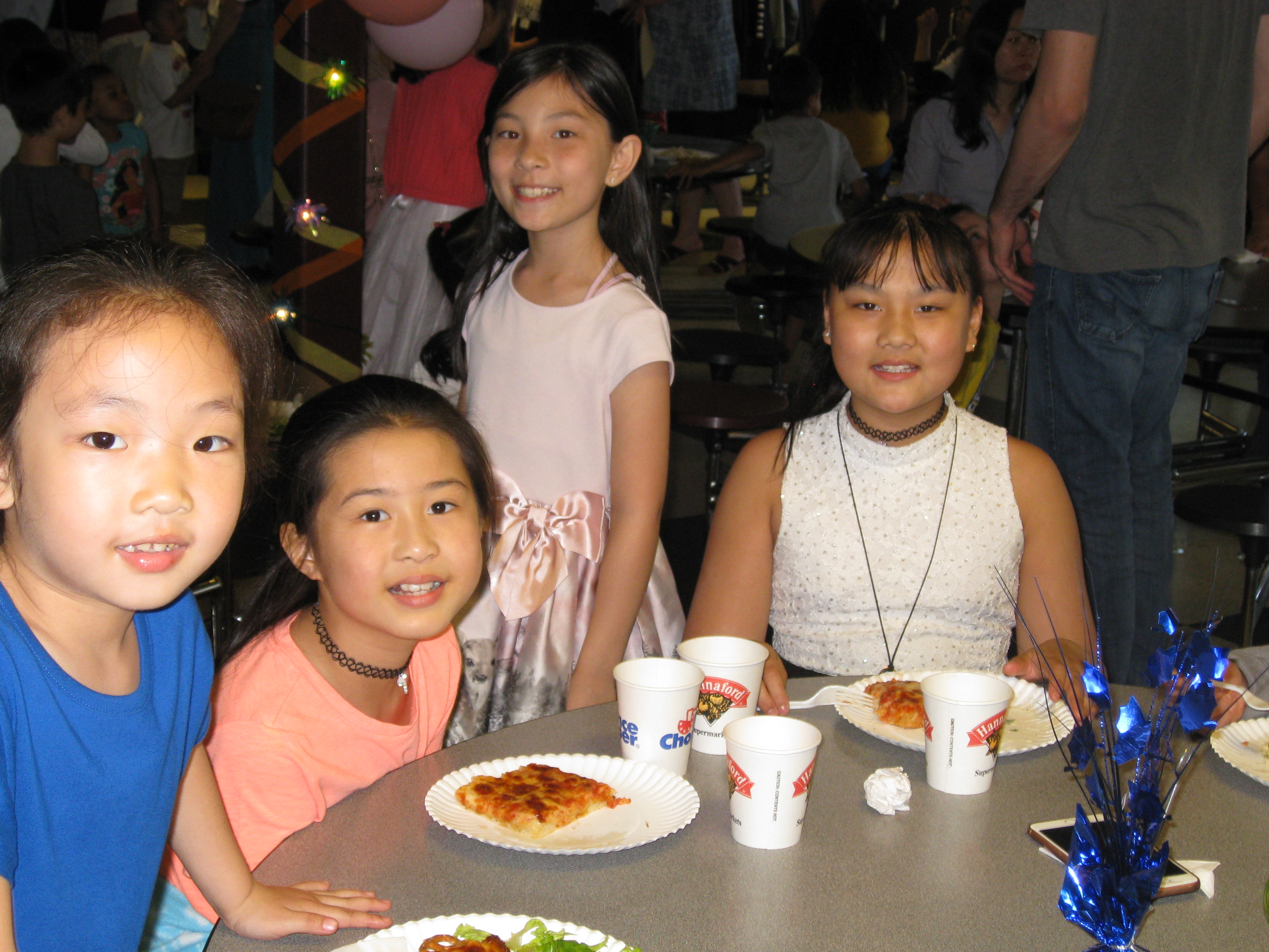 four girls enjoying pizza