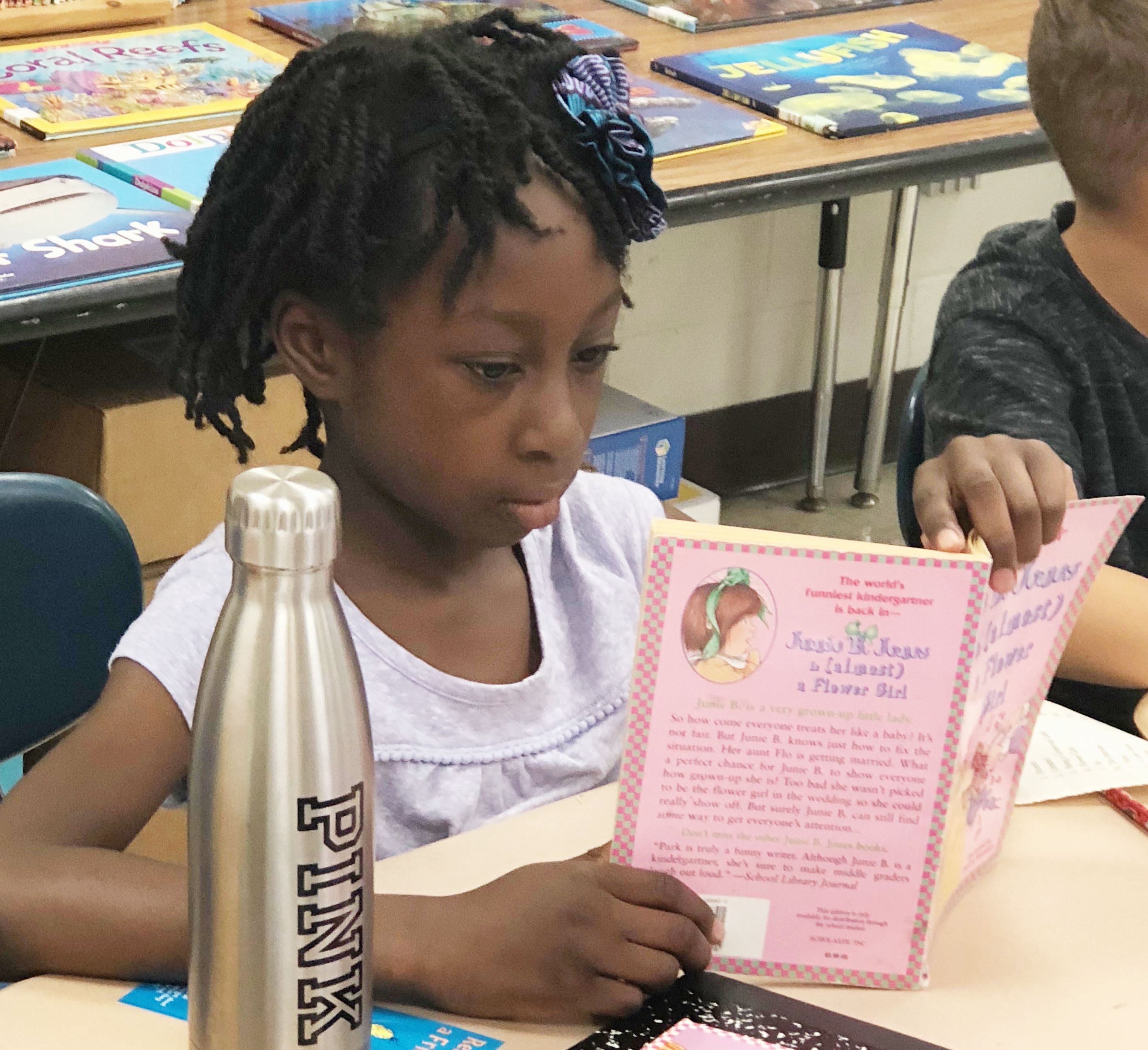 girl reads a book at her desk