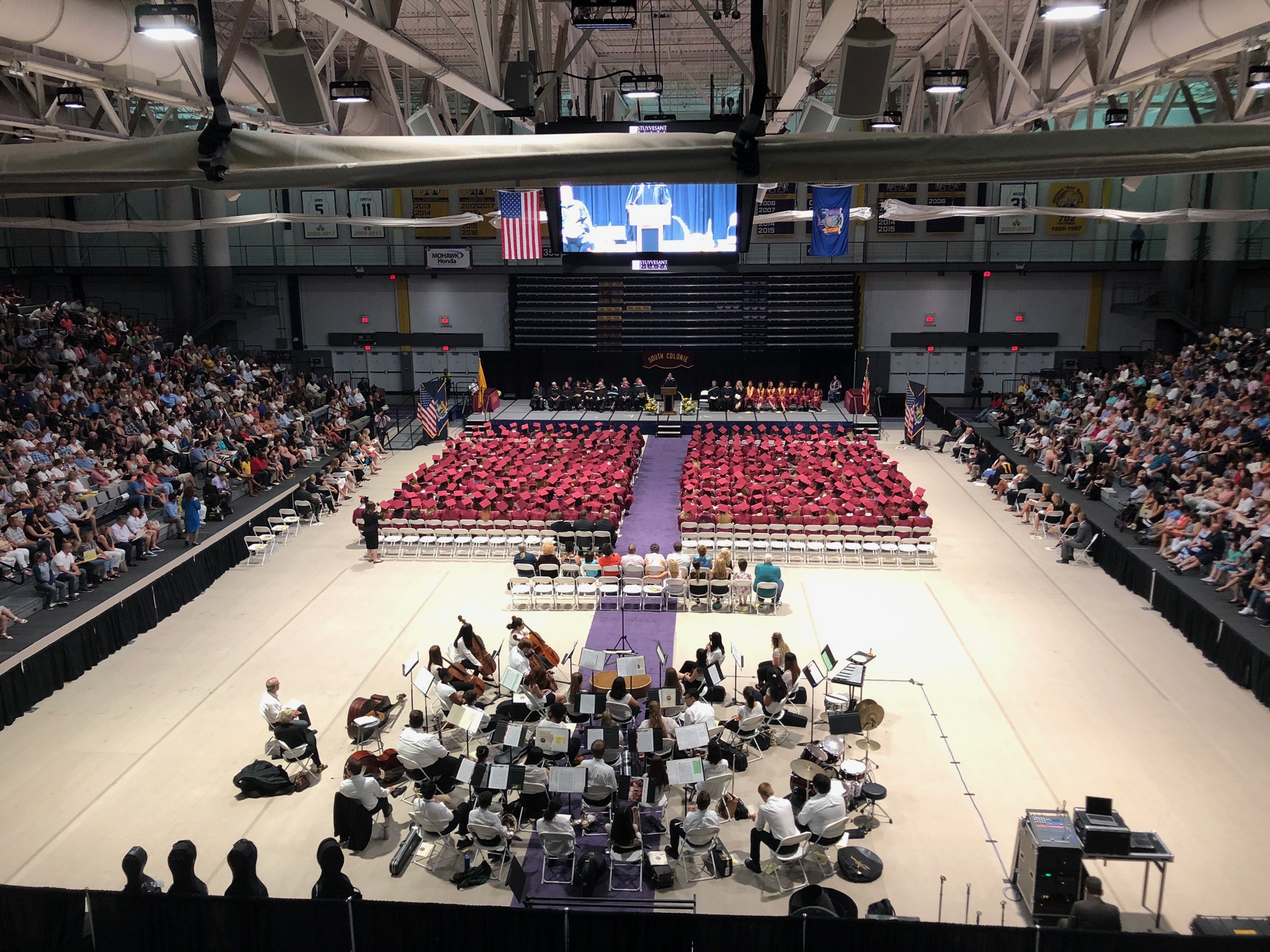 long view of the graduation class  and band