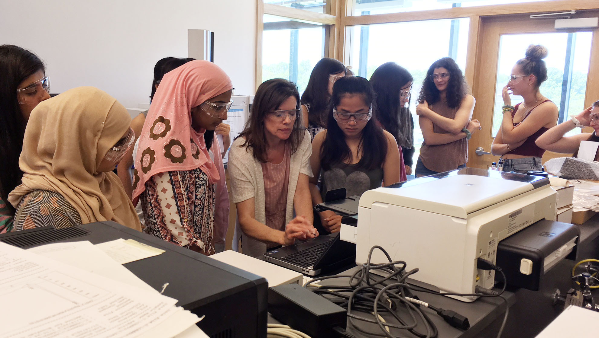 group of high school girl work in a chemistry lab