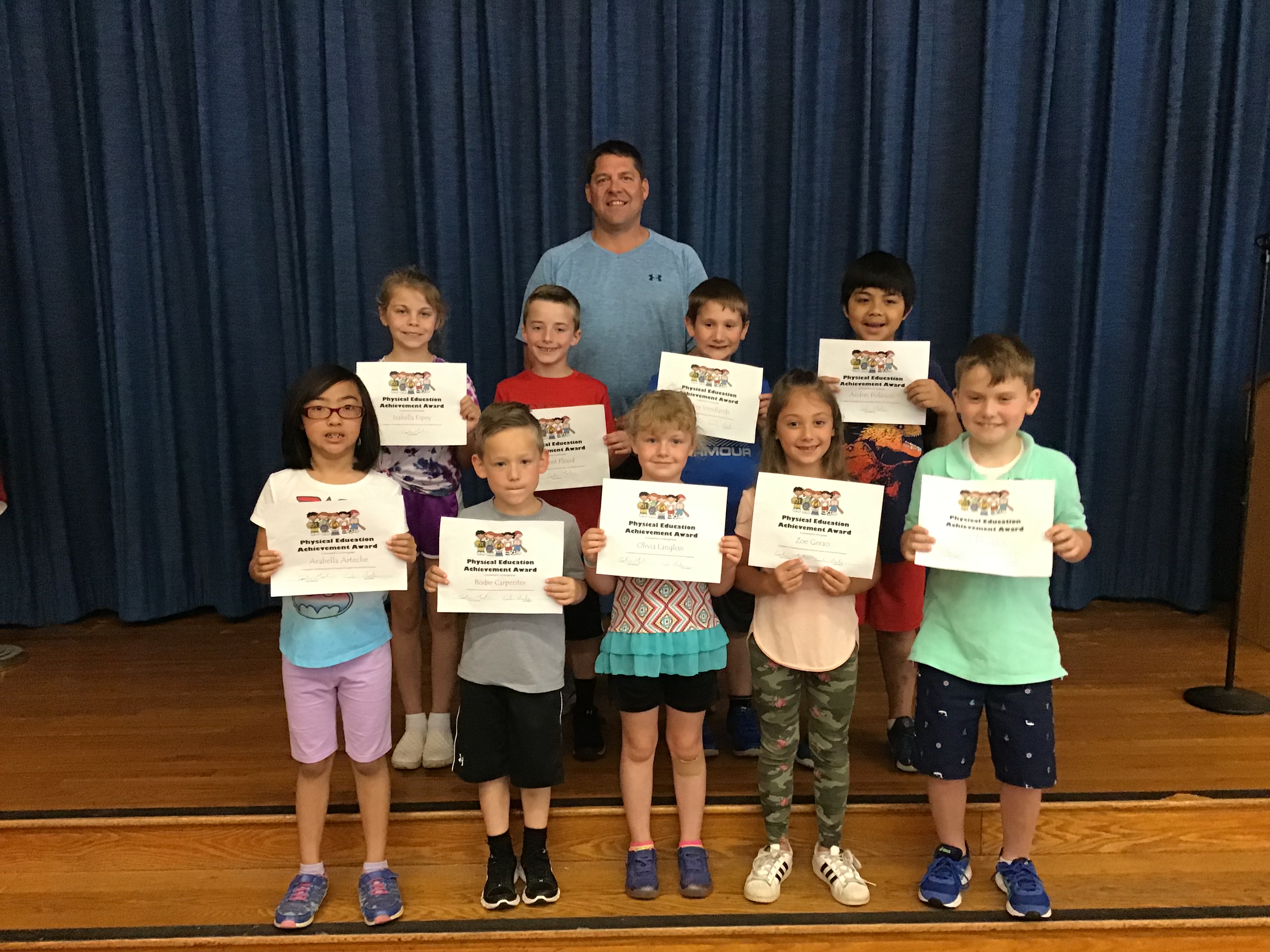 group of student show off their award certificates