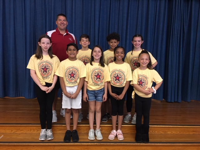 group of students in yellow T shirts and their coach