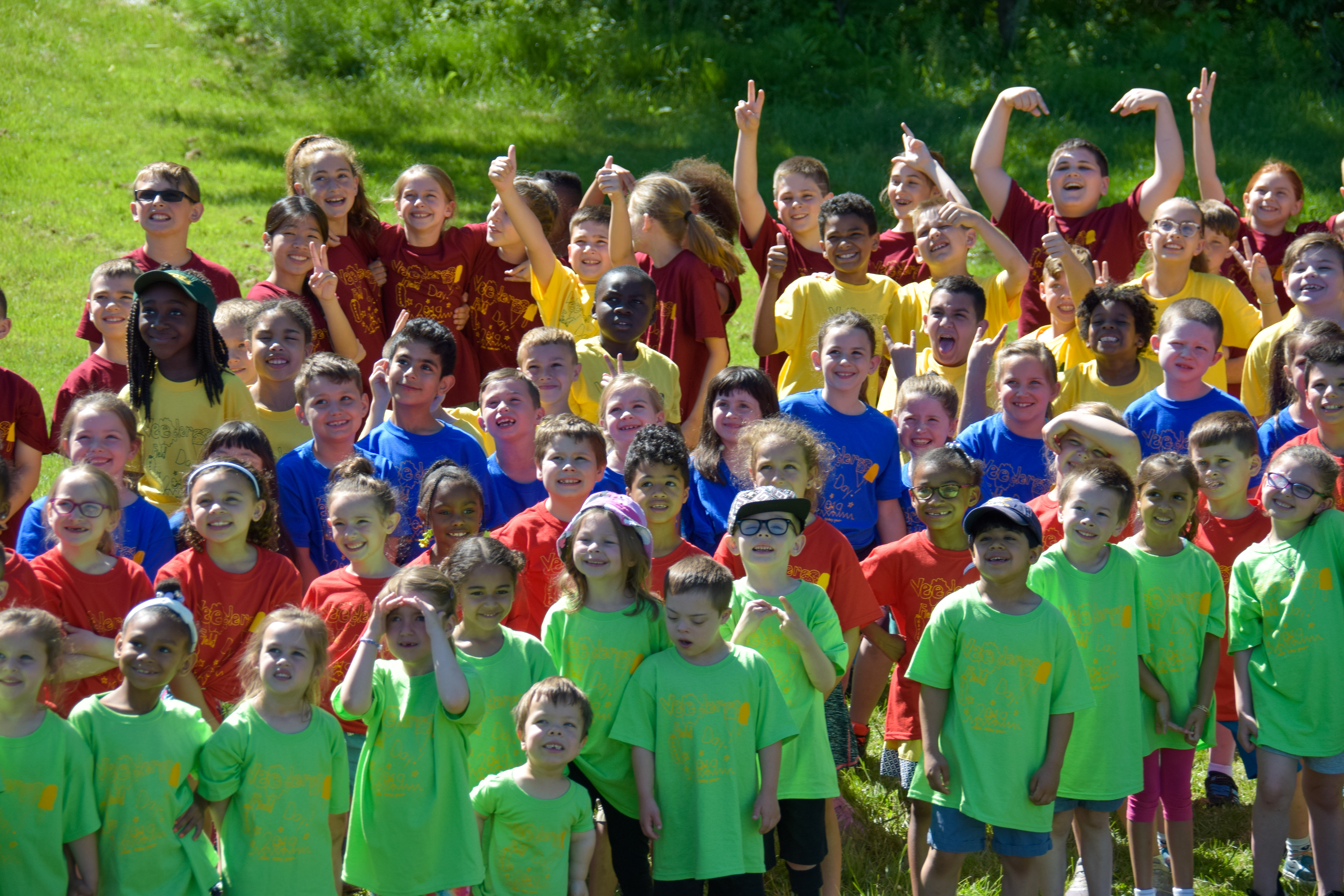 large group of students in colorful t shirts