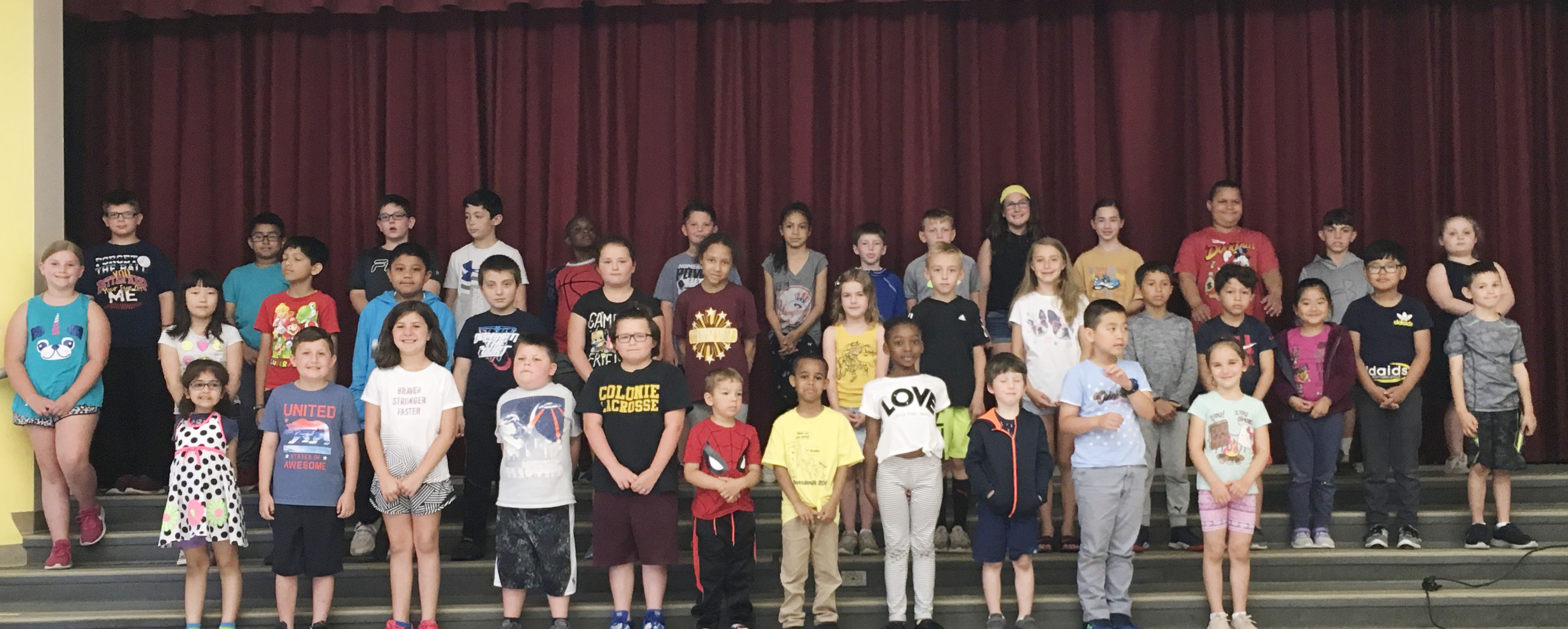 group of elementary student show off their award certificates