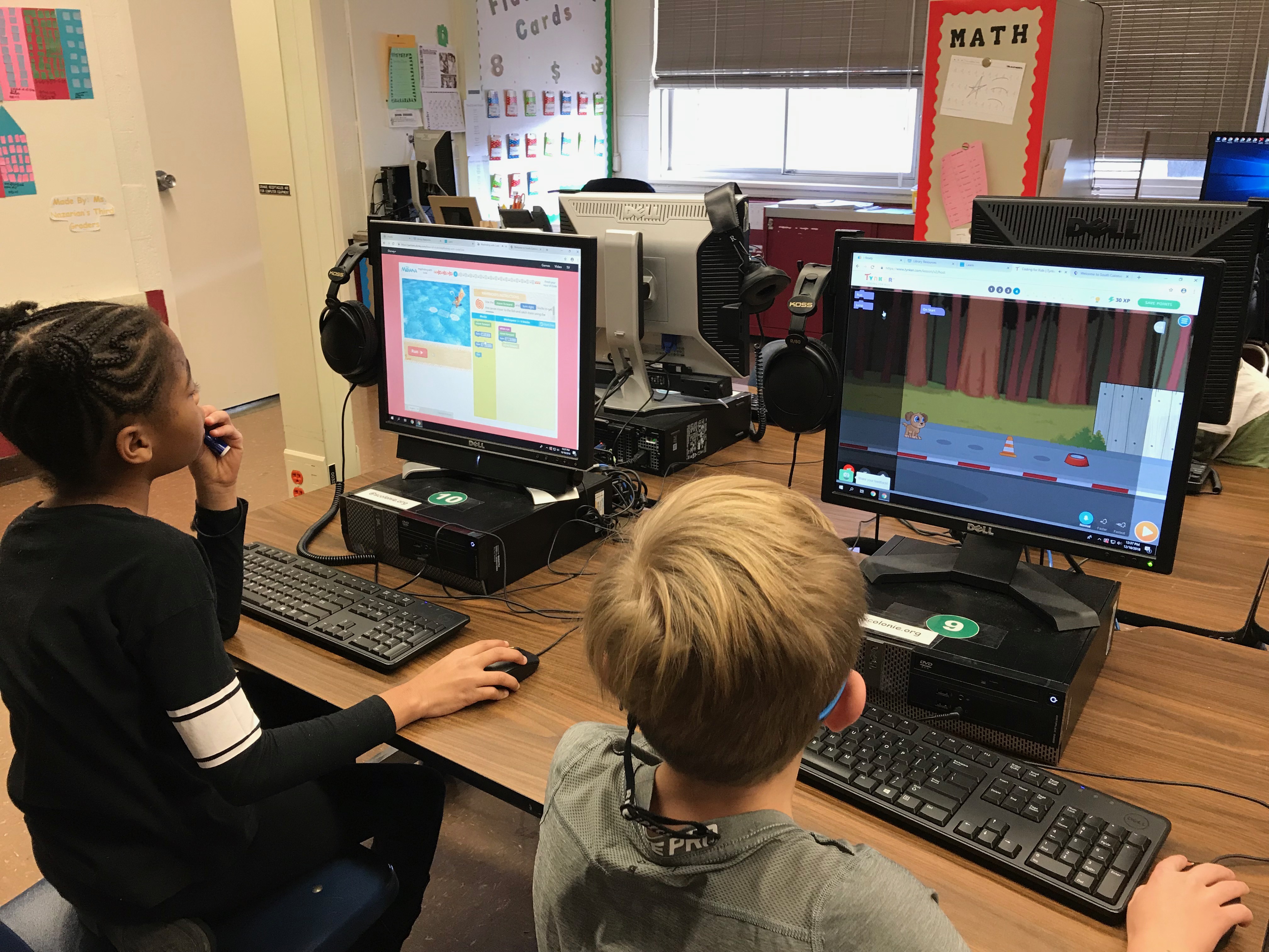 two boys work on computers