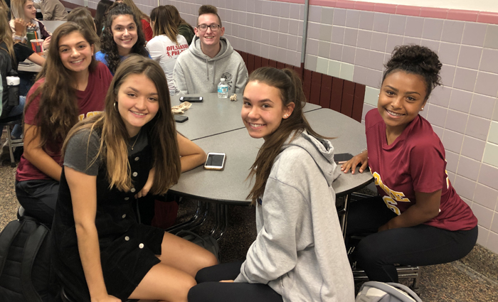 group of high school students at a table