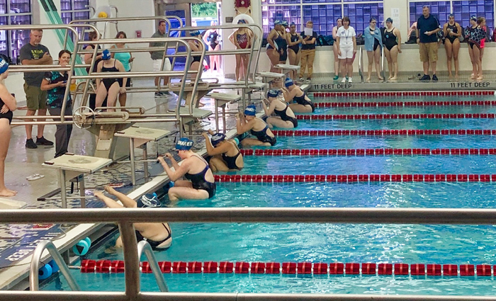 girl swimmers dive into pool