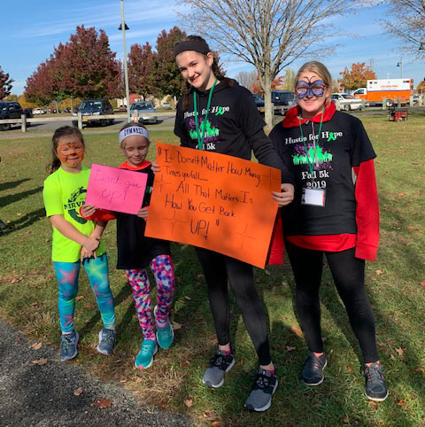 family of runner showing their poster