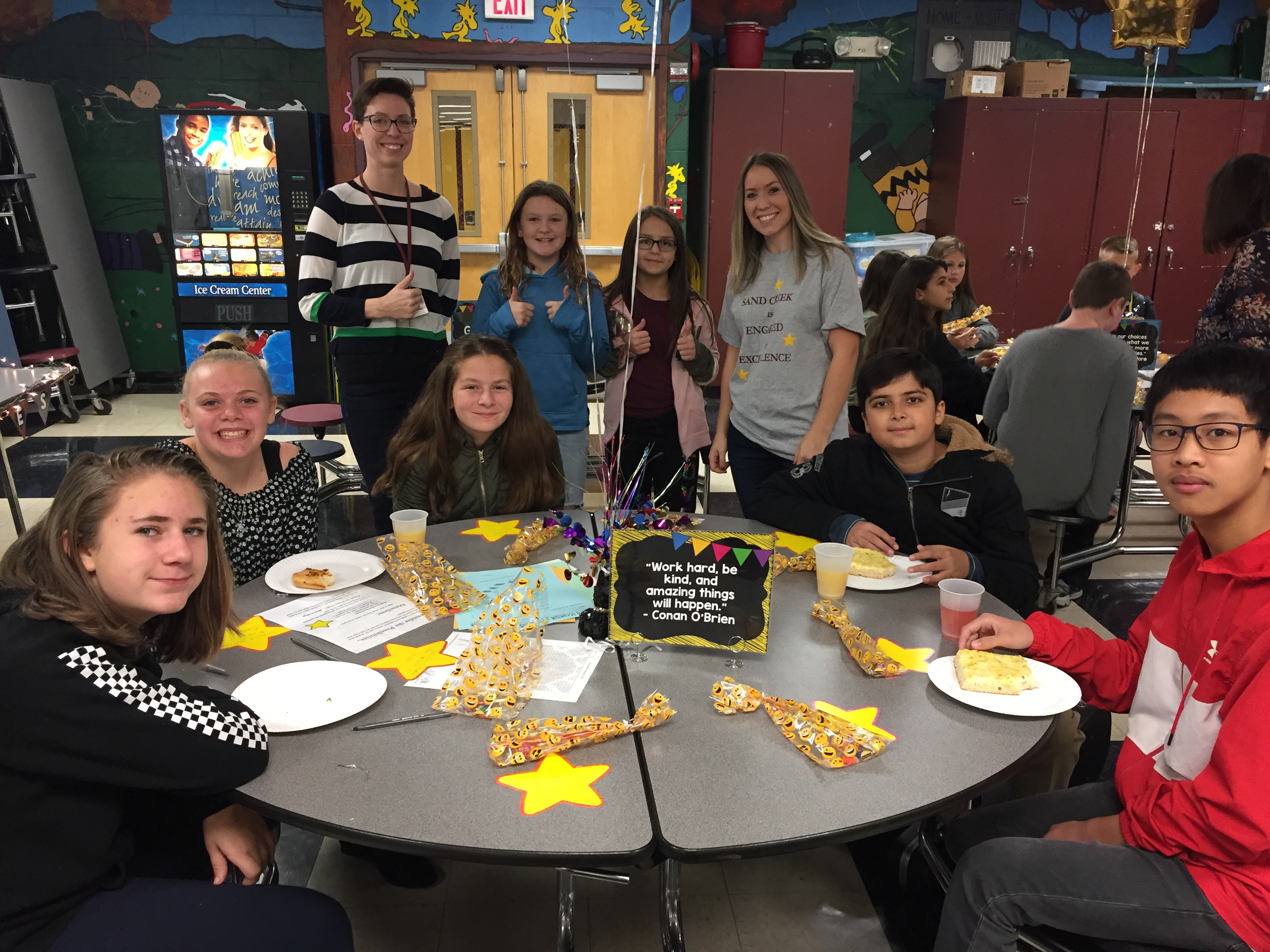 middle school students eat at a cafeteria table