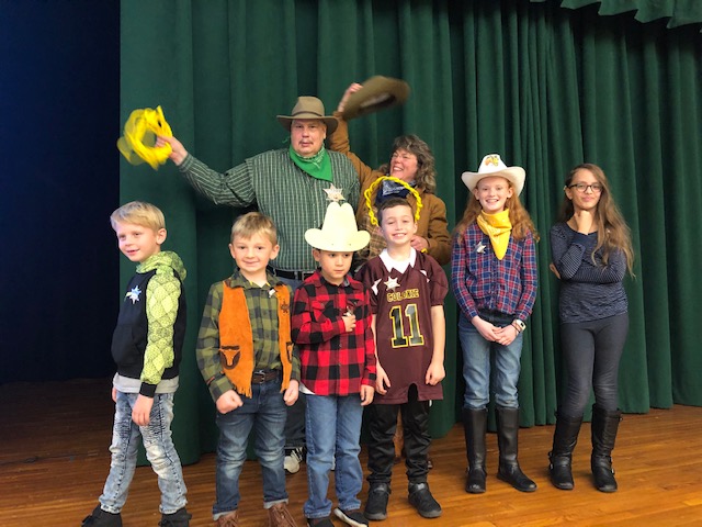 group of students and teacher dressed in cowboy gear