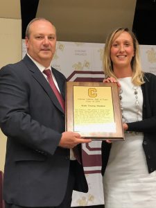 man and woman hold a plaque together