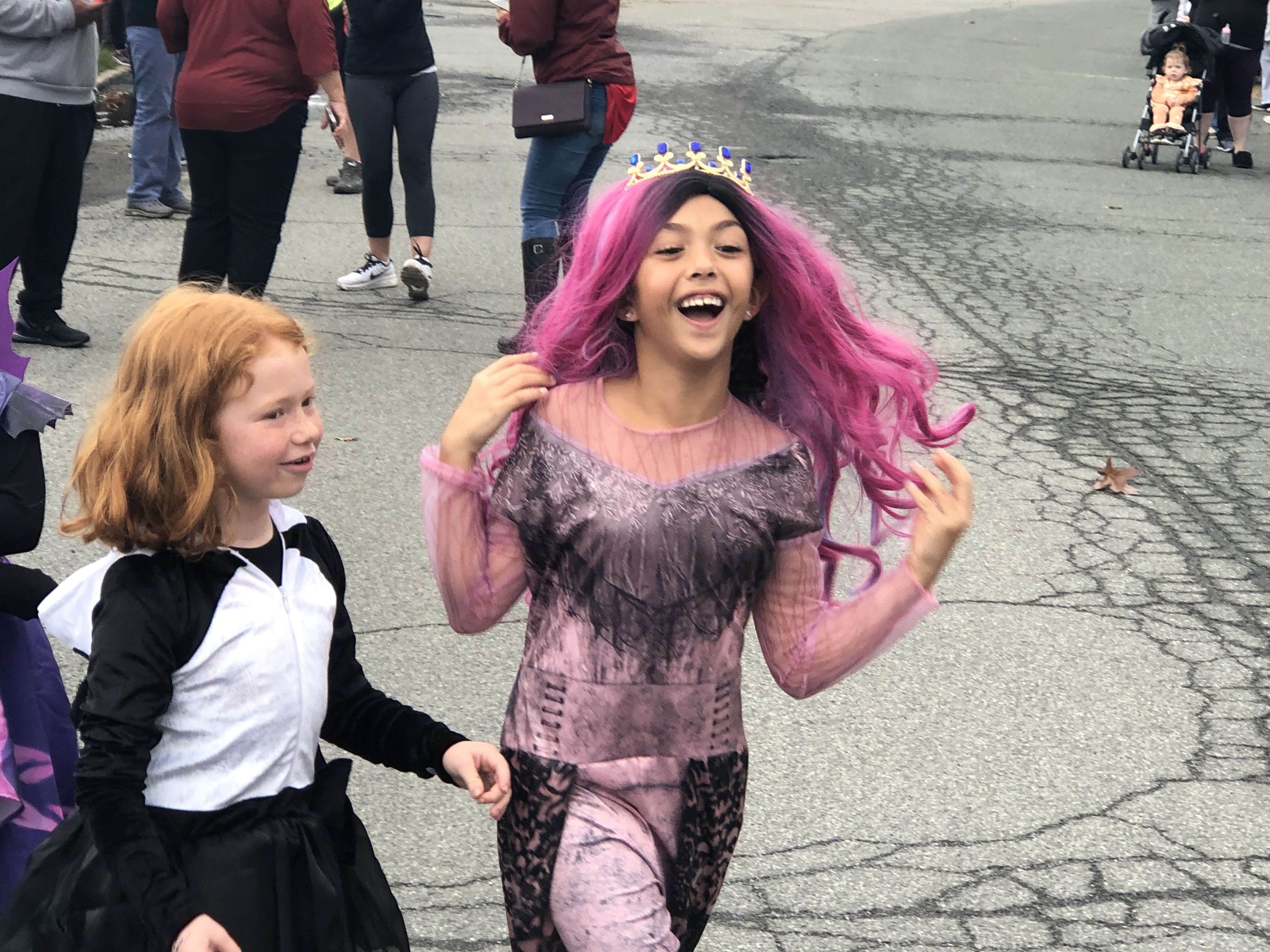 two girls march in Halloween costumes