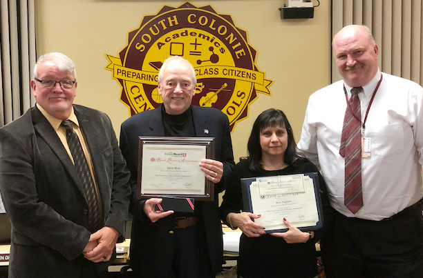 four people in group, 2 with awards