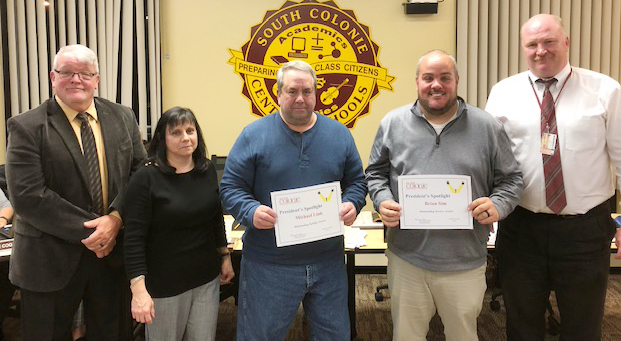 bus personnel holds award certificates with 2 board members and superintendent of schools