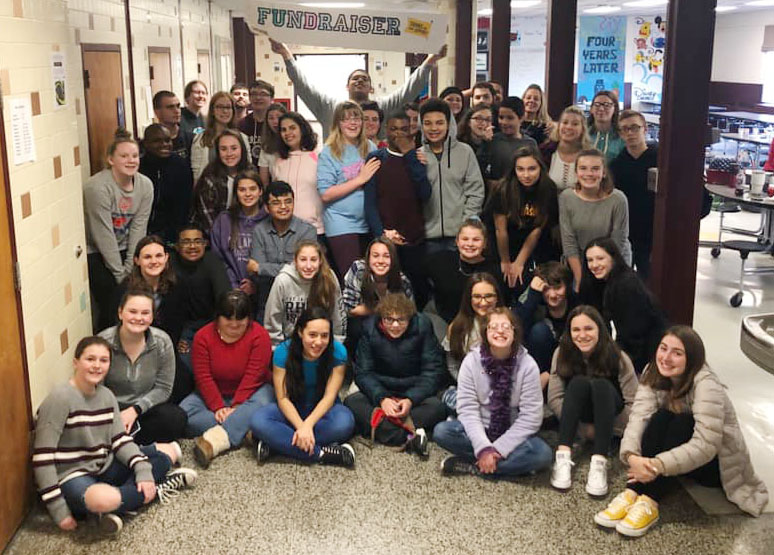 large group of high school students gather for photo