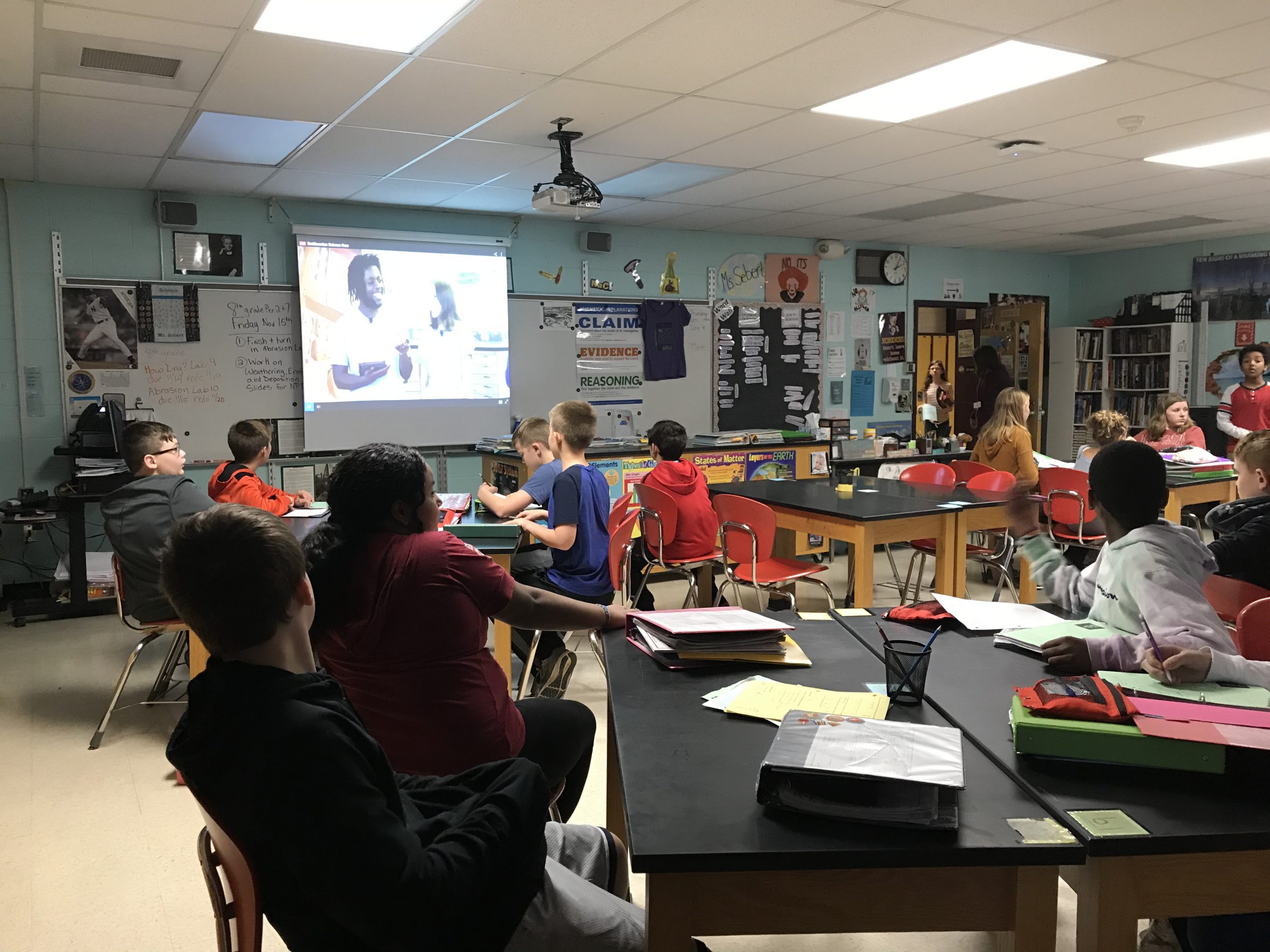 large class of students watching a video conference